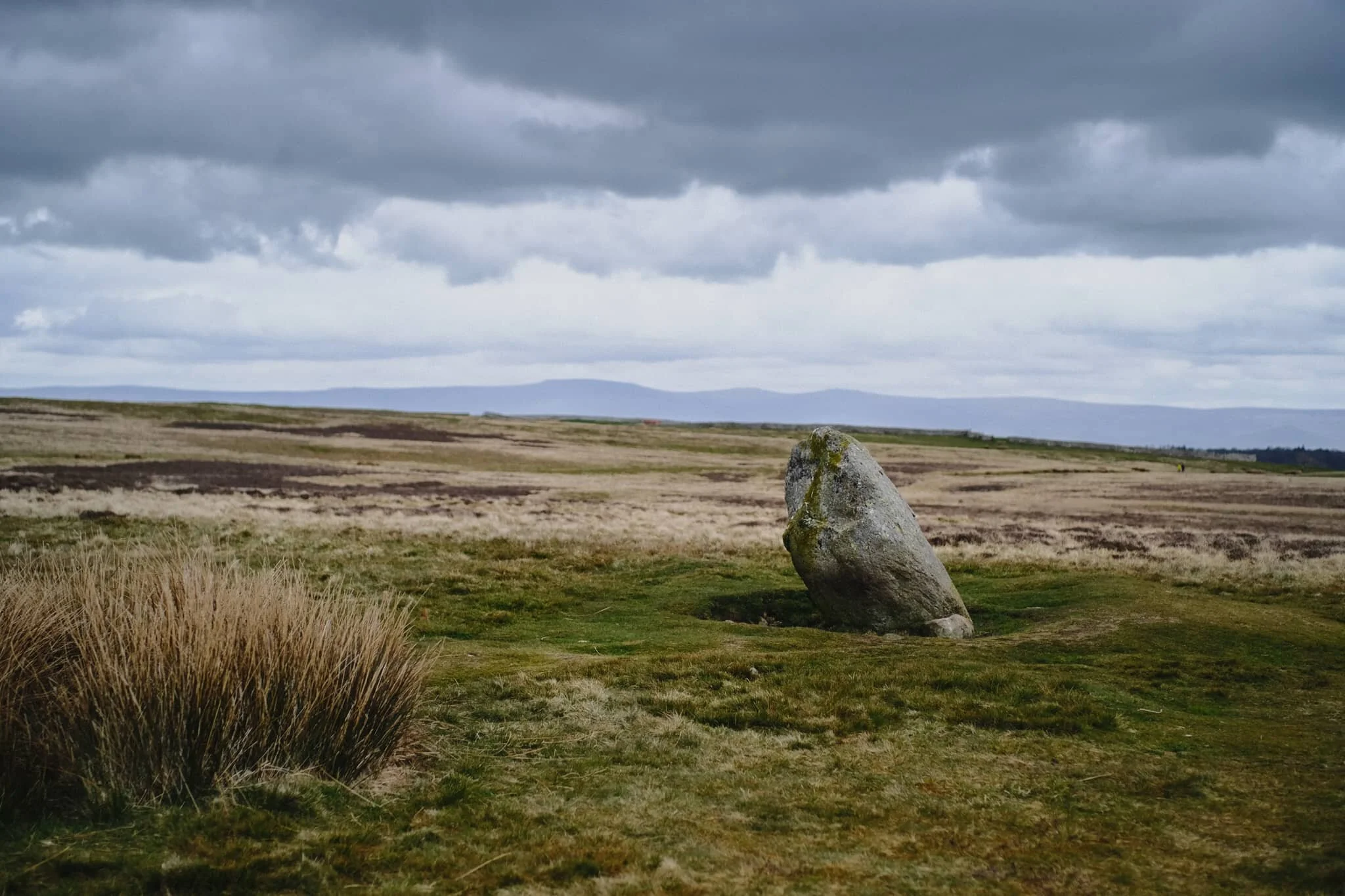 This is the Cop Stone, a standing stone located near the Moor Divock stone circle on Askham Fell. A prehistoric monument, it&rsquo;s reason for being lost in time. In the distance is the unmistakeable wall of the Northern Pennines. 