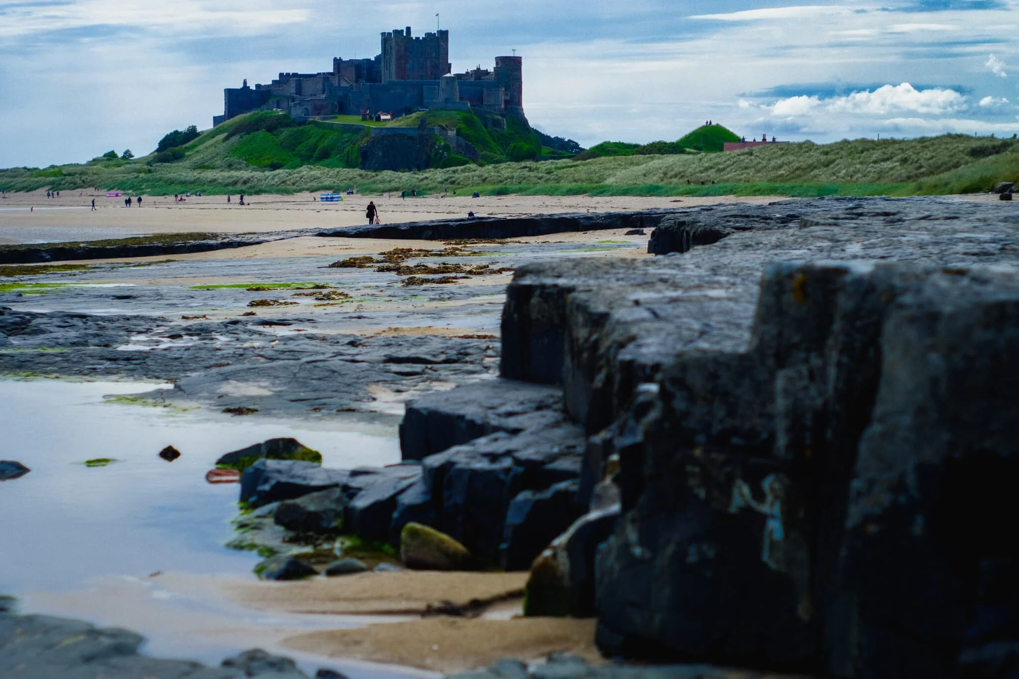  At around midday the beach was quickly filling up with people. I nabbed this quick composition of Bamburgh Castle in the distance with the edge of Harkess Rocks closer to the viewer. 