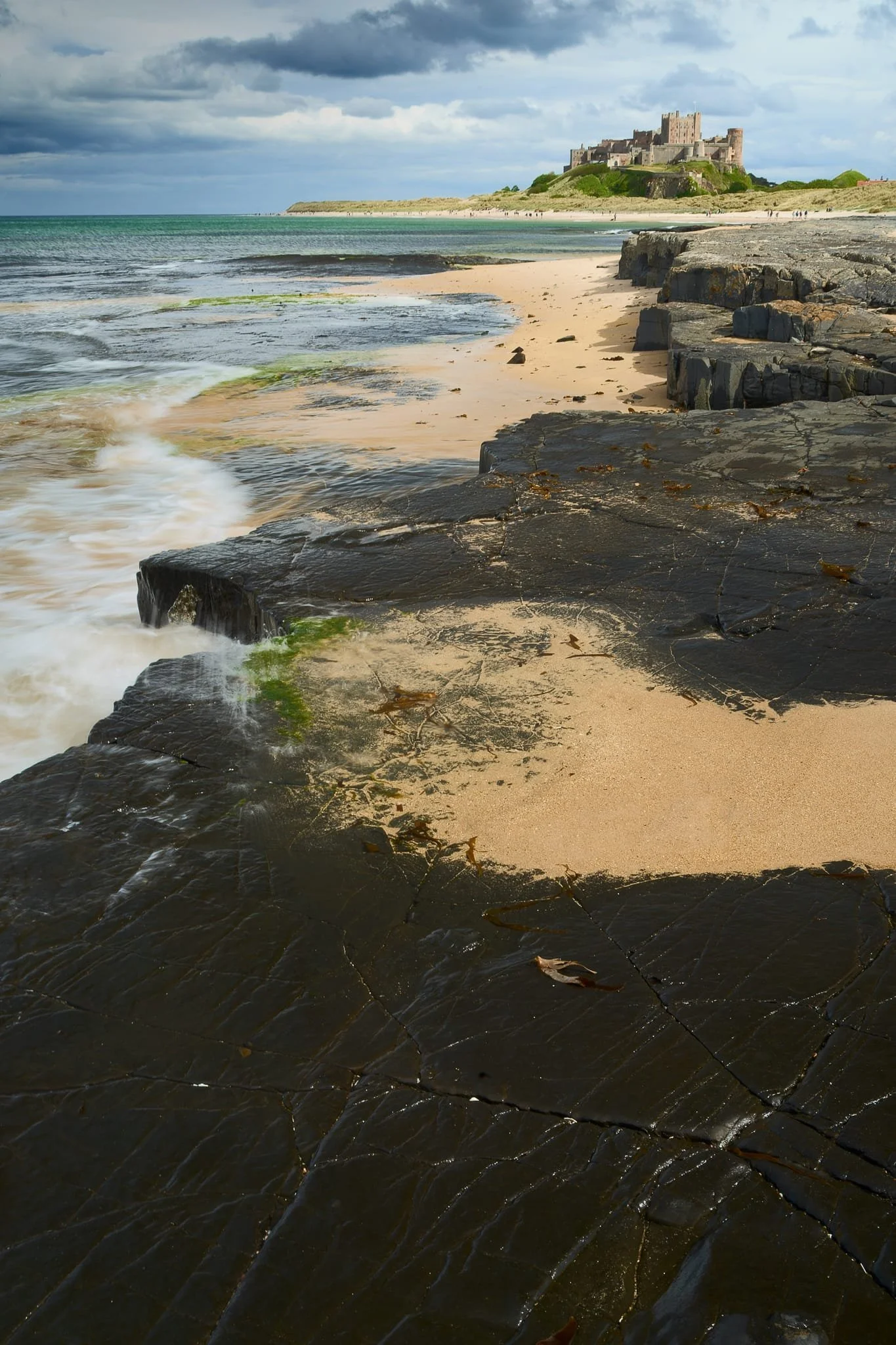 The volcanic origins of the geology around Harkness Rocks has created this raised platform above the sand, which the incoming tide was slamming against. This was another of those occasions where I took multiple tries of this composition, waiting for the waves to smash in just the right way.