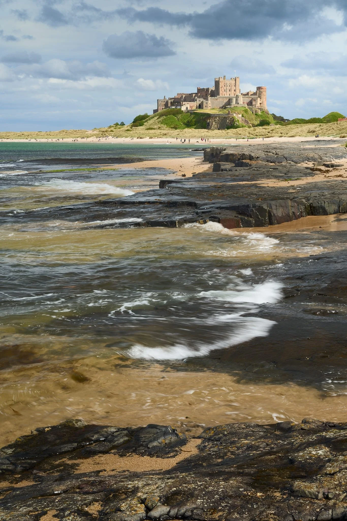 A tighter composition, using the crashing of the waves as a leading line itself towards the raised rocks and Bamburgh Castle itself.