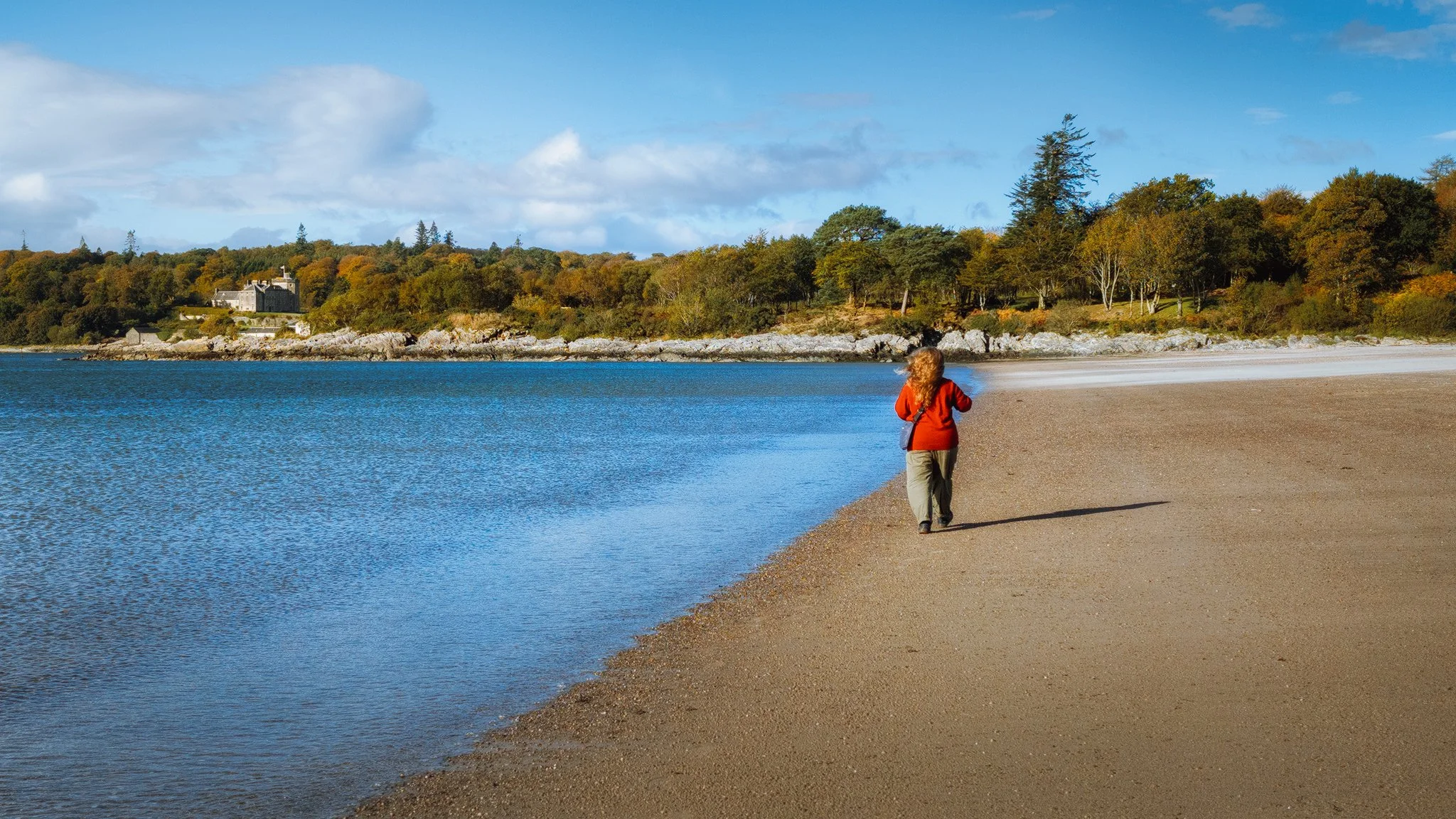  My Lisabet, in her happy place, waltzing along a windy Benderloch beach. Up above the crags of the northern side of the bay is Lochnell House, a battlemented mansion originally built in the 15th century, and fully restored after a fire in the late 1800s. 