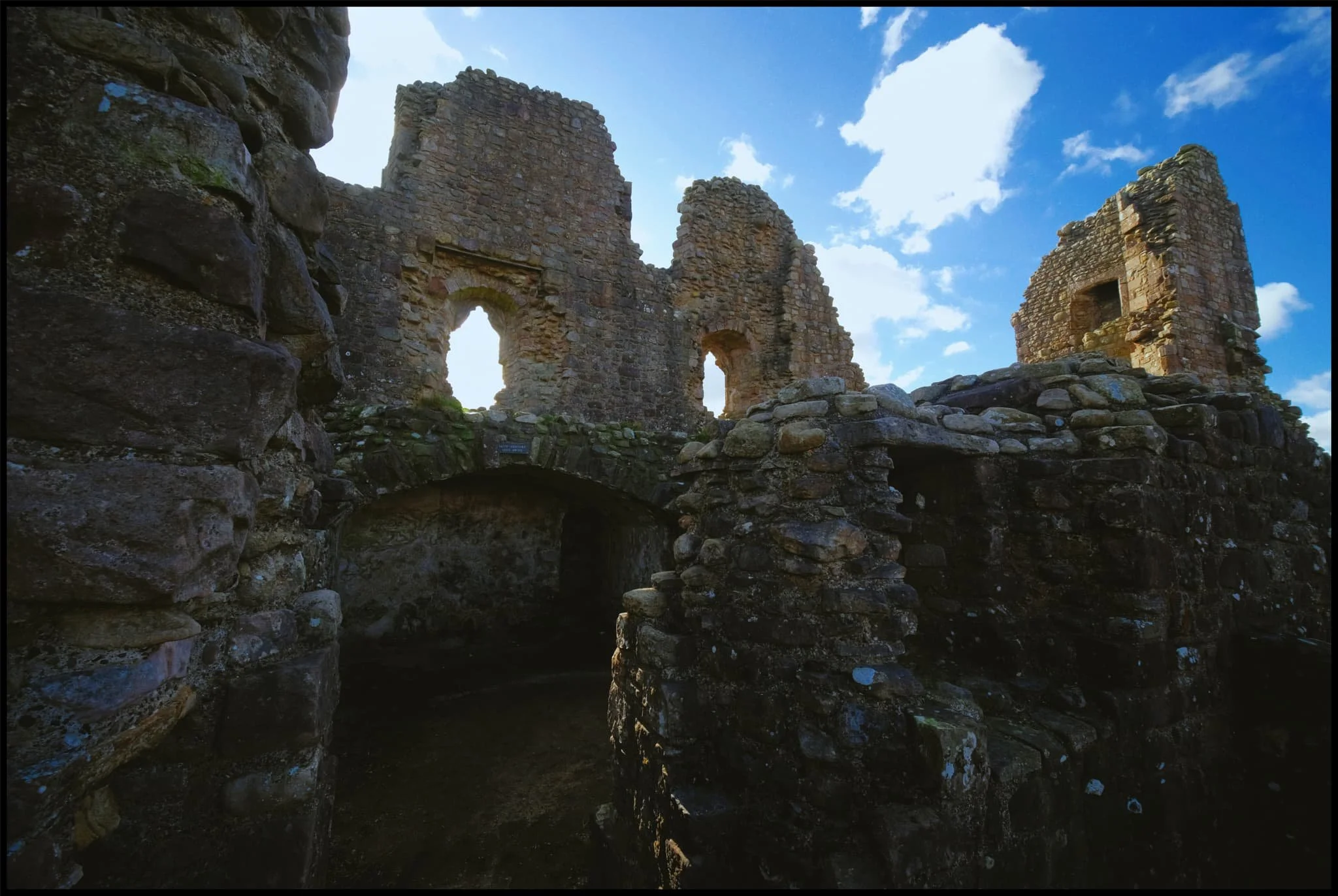  These hall ranges were last modified in the 14th-century. To the right, high up, is the high wall of the gatehouse. 