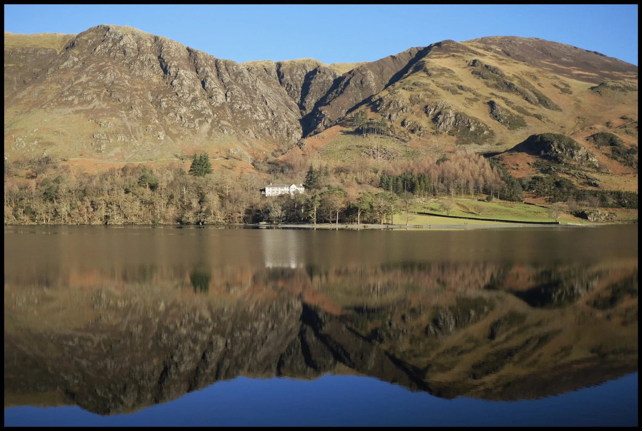 Across the water from Buttermere&rsquo;s southwestern shore, Hassness Country House is a veritable beacon in the low wintersun. 
