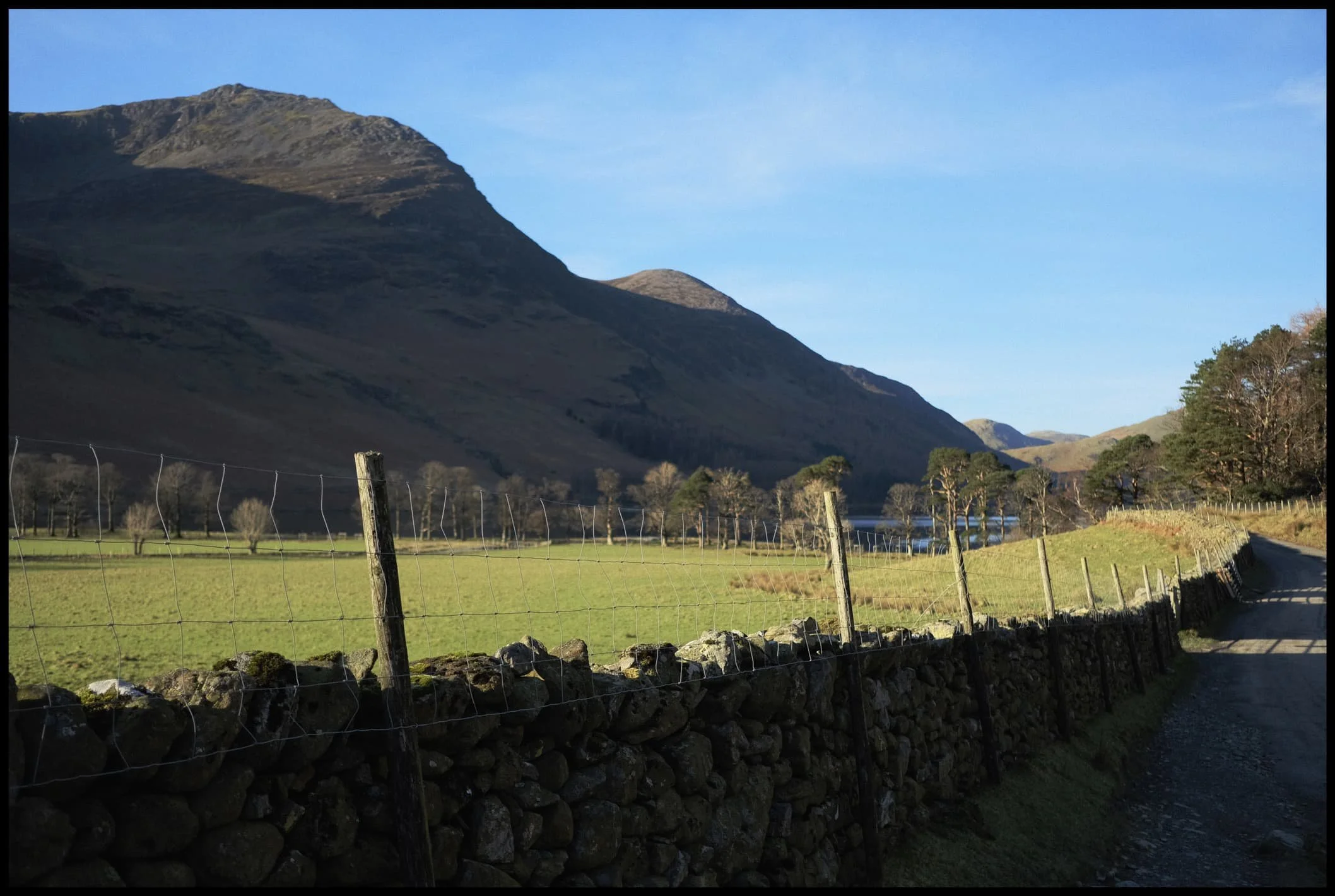  From Buttermere&rsquo;s northeastern side, the profile of the High Stile range becomes more apparent. There are three main peaks: High Crag, High Stile, and Red Pike.  
