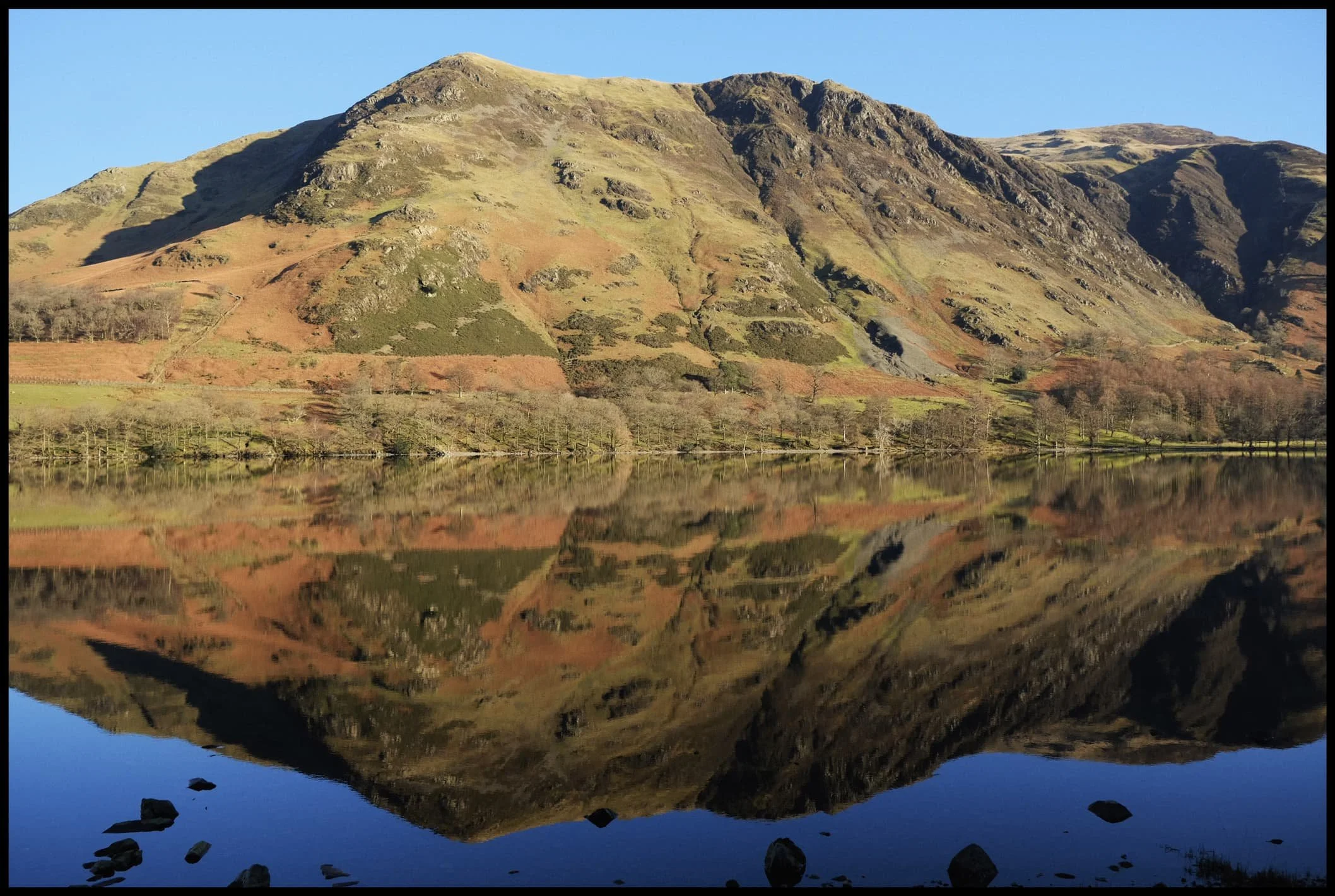  Directly across Buttermere, the Robinson fell crags of High Snockrigg and Goat Crag are illuminated in the late-morning wintersun. 