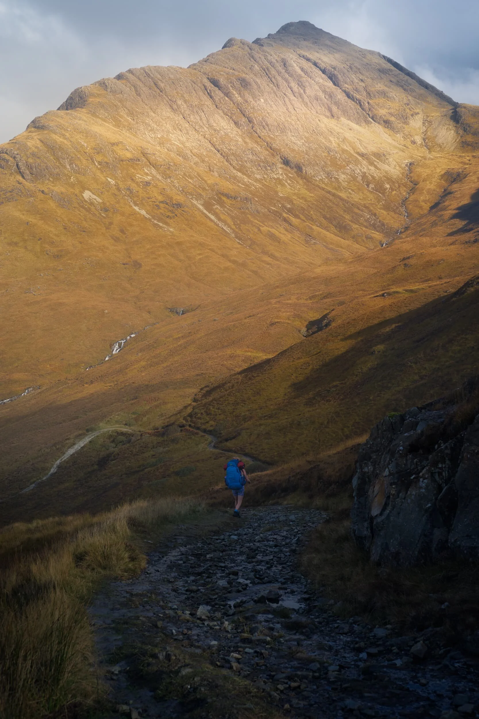  As we began following the trail down to Camasunary Bay we were faced with the massive southern face of  Blà Bheinn  (928 m/3,044 ft) high above, glowing gold in the morning sun. We also weren&rsquo;t the only ones enjoying this hike. 