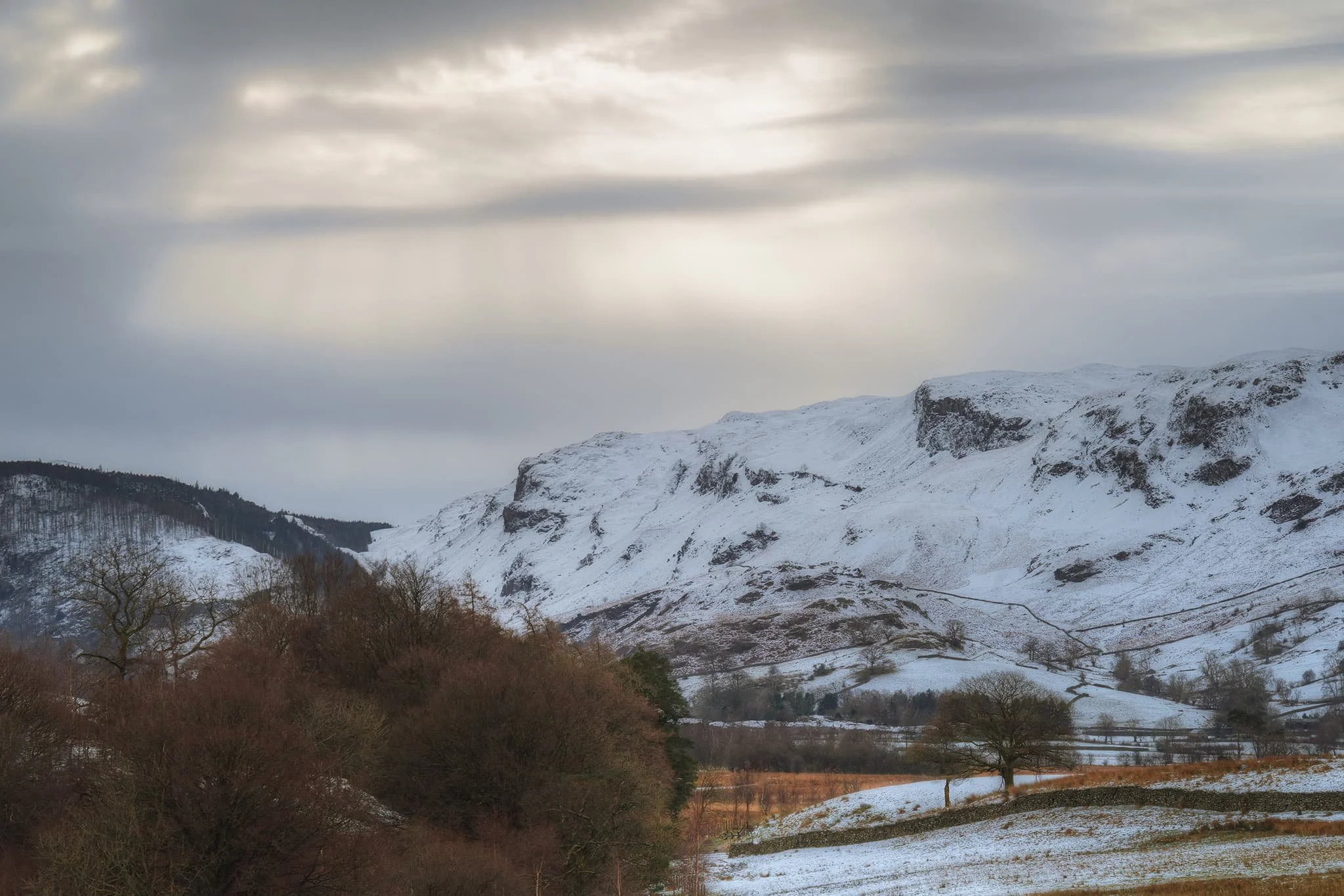 The last of the light, looking back towards the Thirlmere fells. Layers of cloud temporarily reveal the sun in the form of crepuscular rays of “God rays”. Just truly magical.