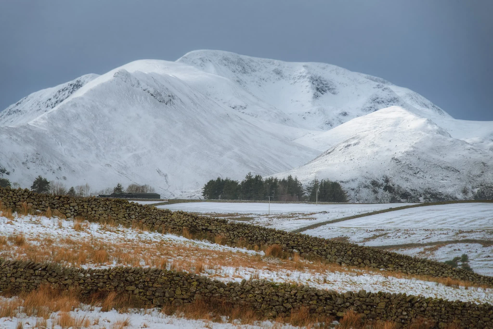 Nearing the plateau where Tewet Tarn is located, I scan the westerly horizon at all the beautifully snowy fells. I zoom in tight, to pick each one individually. This I believe is Crag Hill (839 m/2,753 ft).
