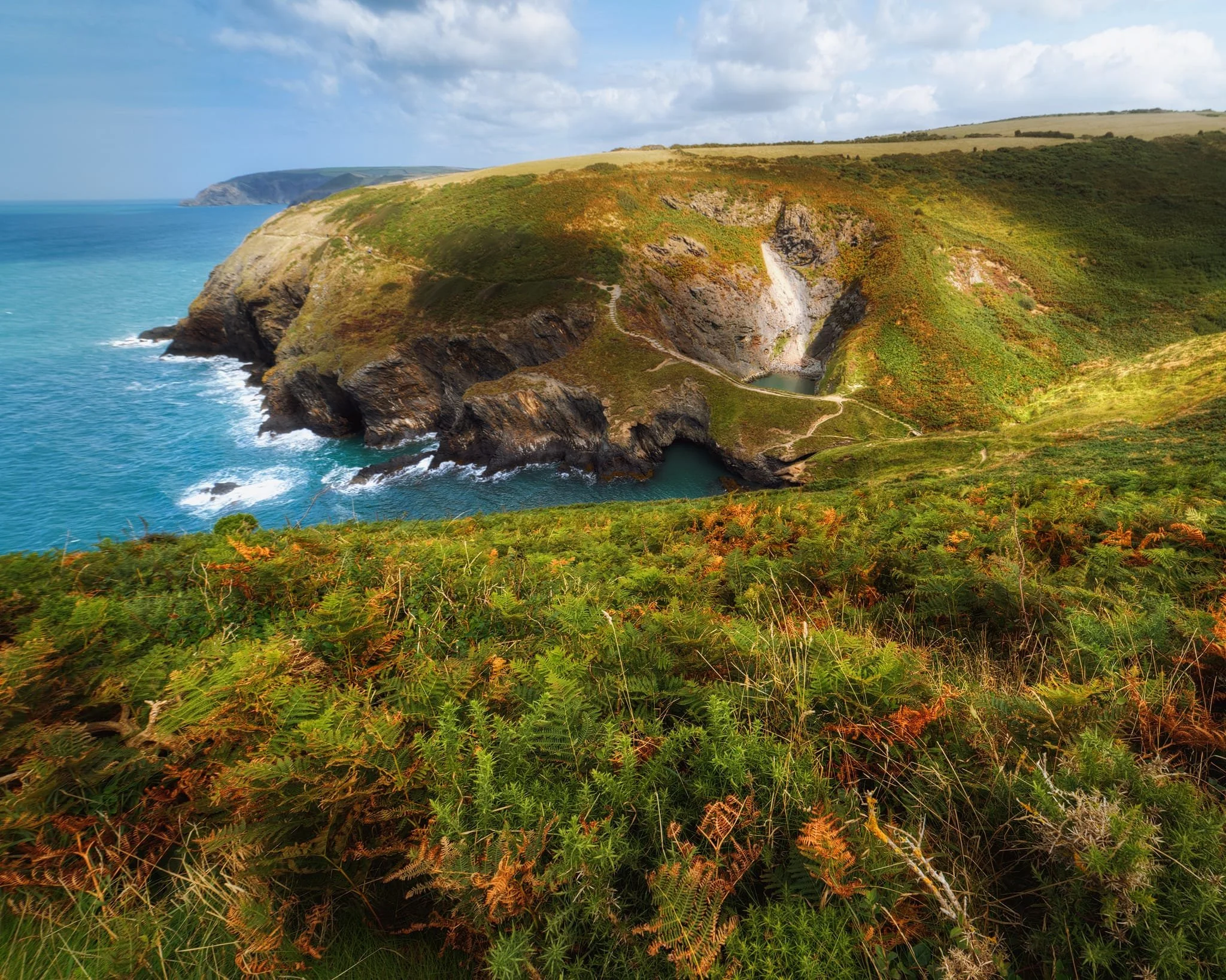  Further southwest from above, it&rsquo;s clear to see how  Pwll y Wrach  is a collapsed cave. Who knows how long the land bridge separating the cauldron from the sea will last? 