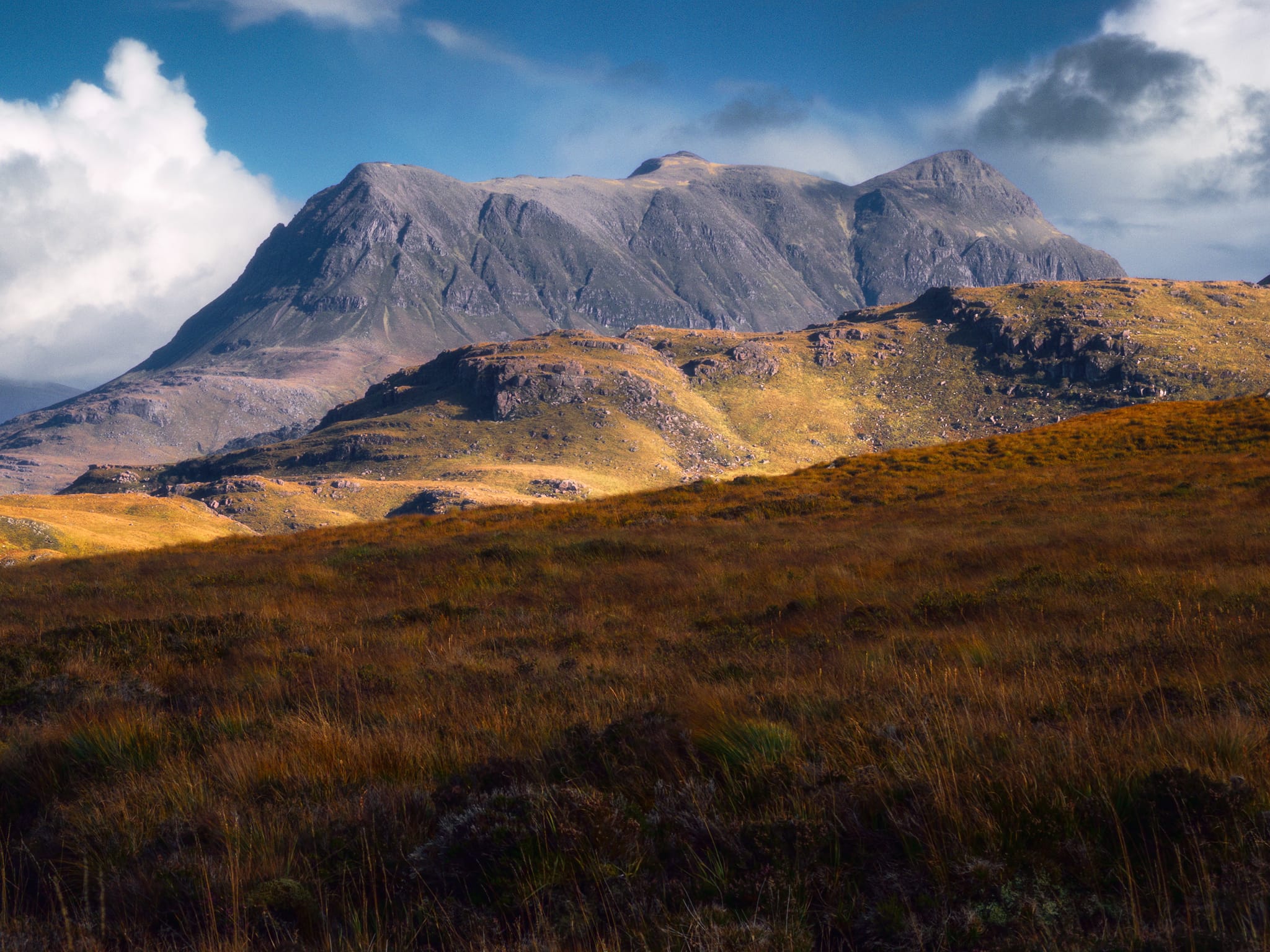 Staying zoomed in, I waited for the light to specifically highlight the distant mountain of Cùl Mòr and its western profile, the shoulder of Stac Pollaidh providing the middle ground.