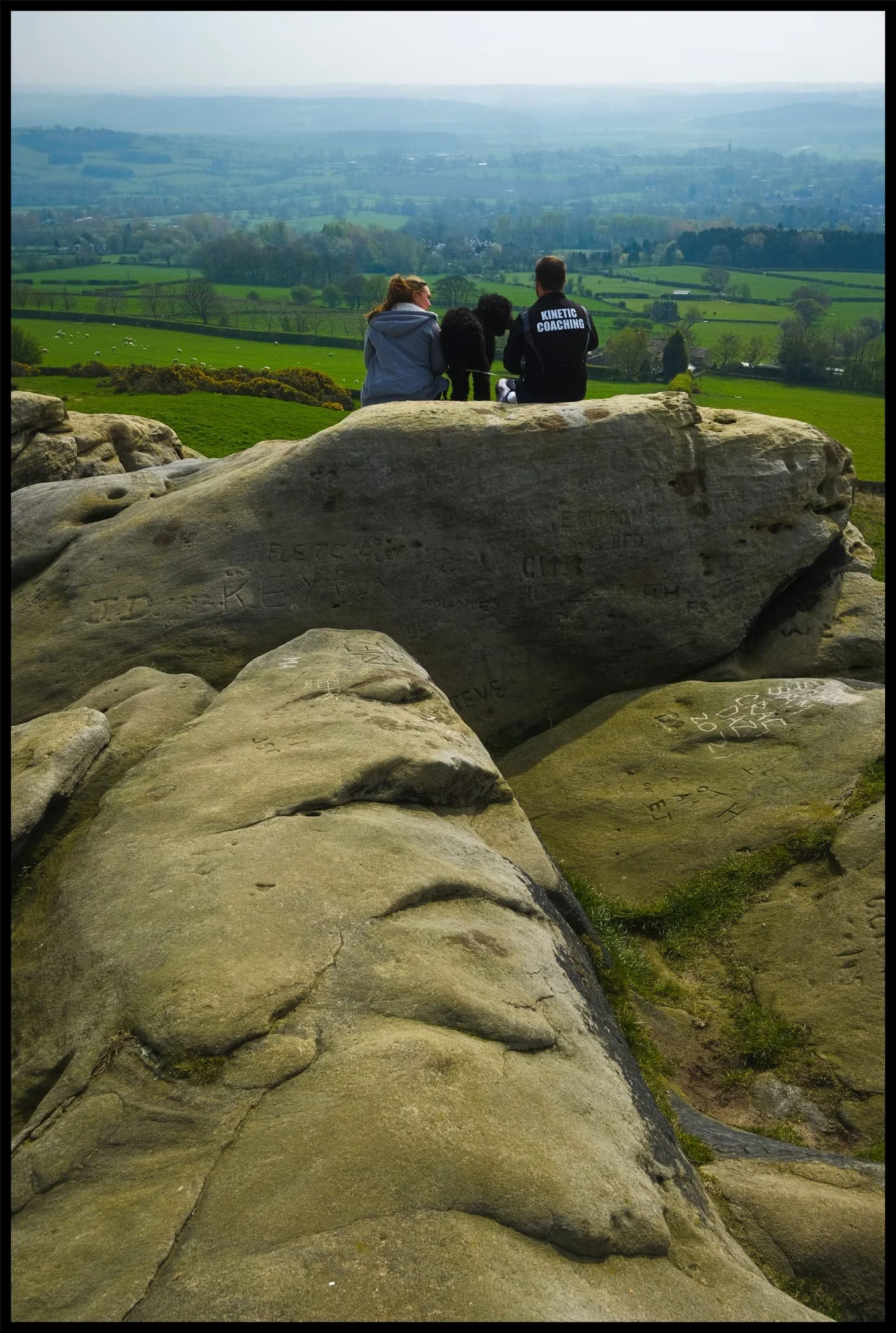  A couple and their pooch enjoy the summit views that stretch out for miles and miles. 