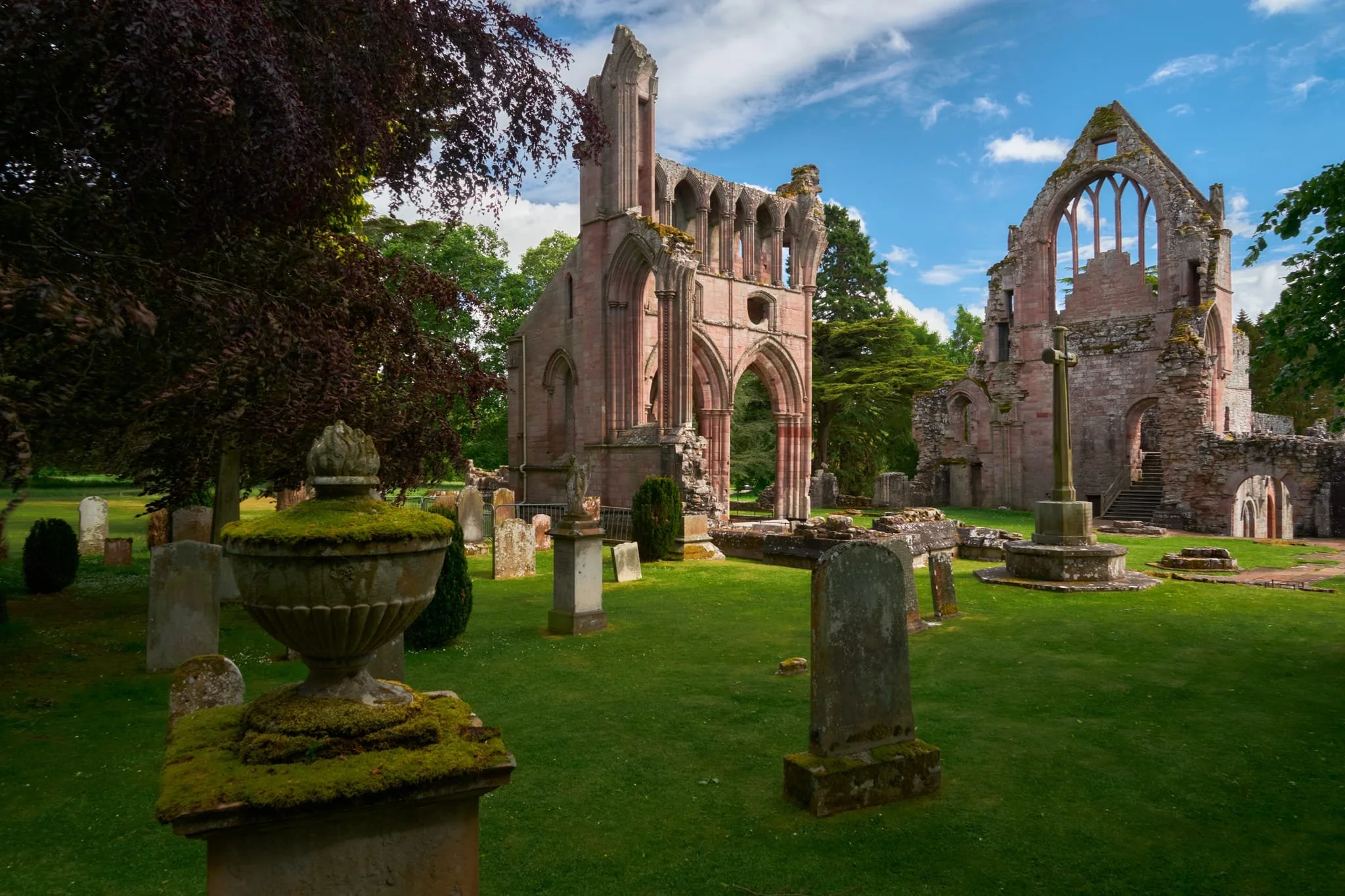  And behold, the ruins of Dryburgh Abbey. It&rsquo;s red colour comes from being primarily constructed from Devonian sandstone. The tall structure centre is the North Transept, representing the most complete surviving portion of the original abbey church. The structure on the right is the East Range, the remains of the monastic domestic buildings. 