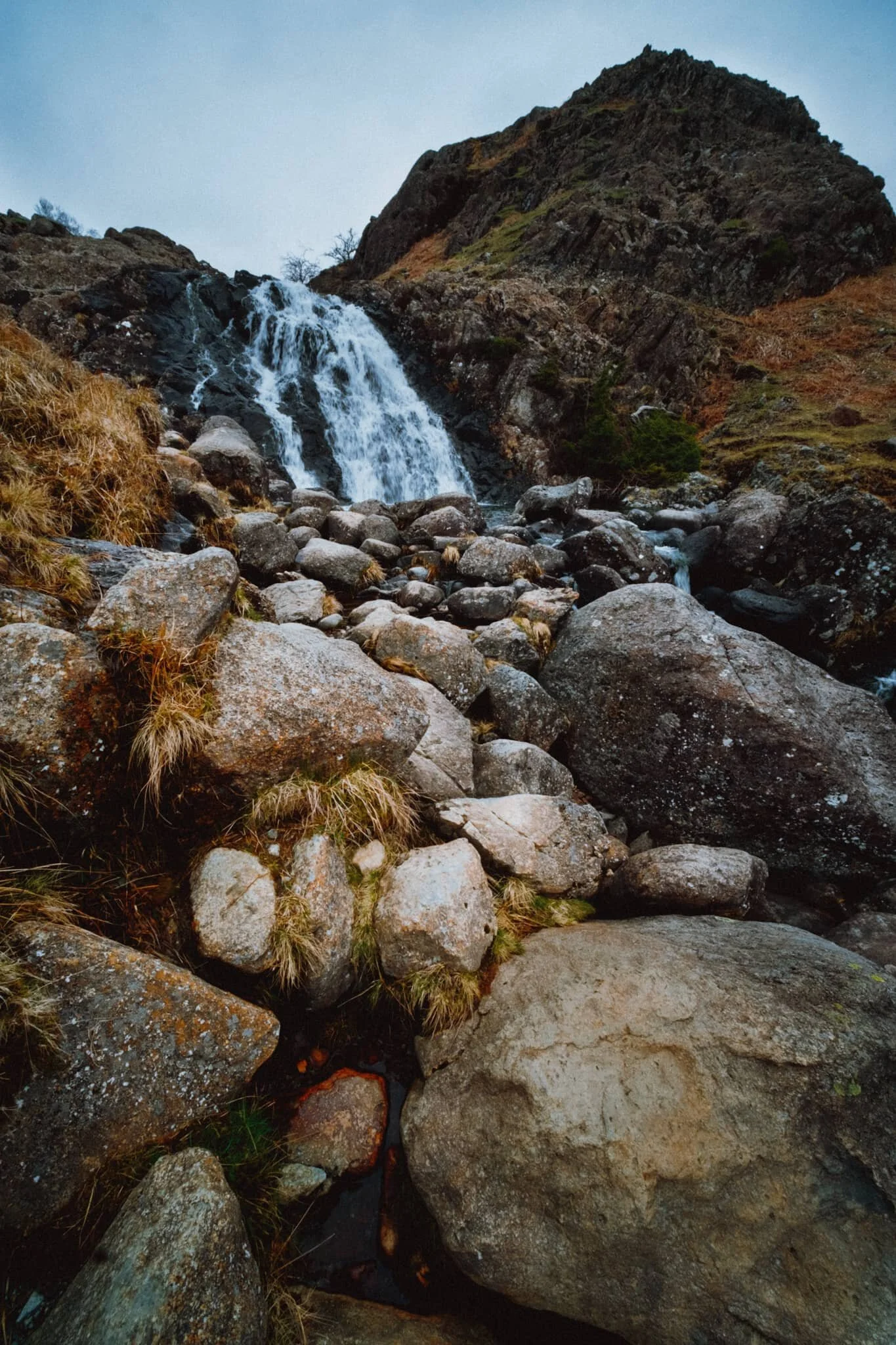 The milky-white waters of Sourmilk Gill, with Elton Crag looming above like a giant knuckly first punching defiantly into the sky.