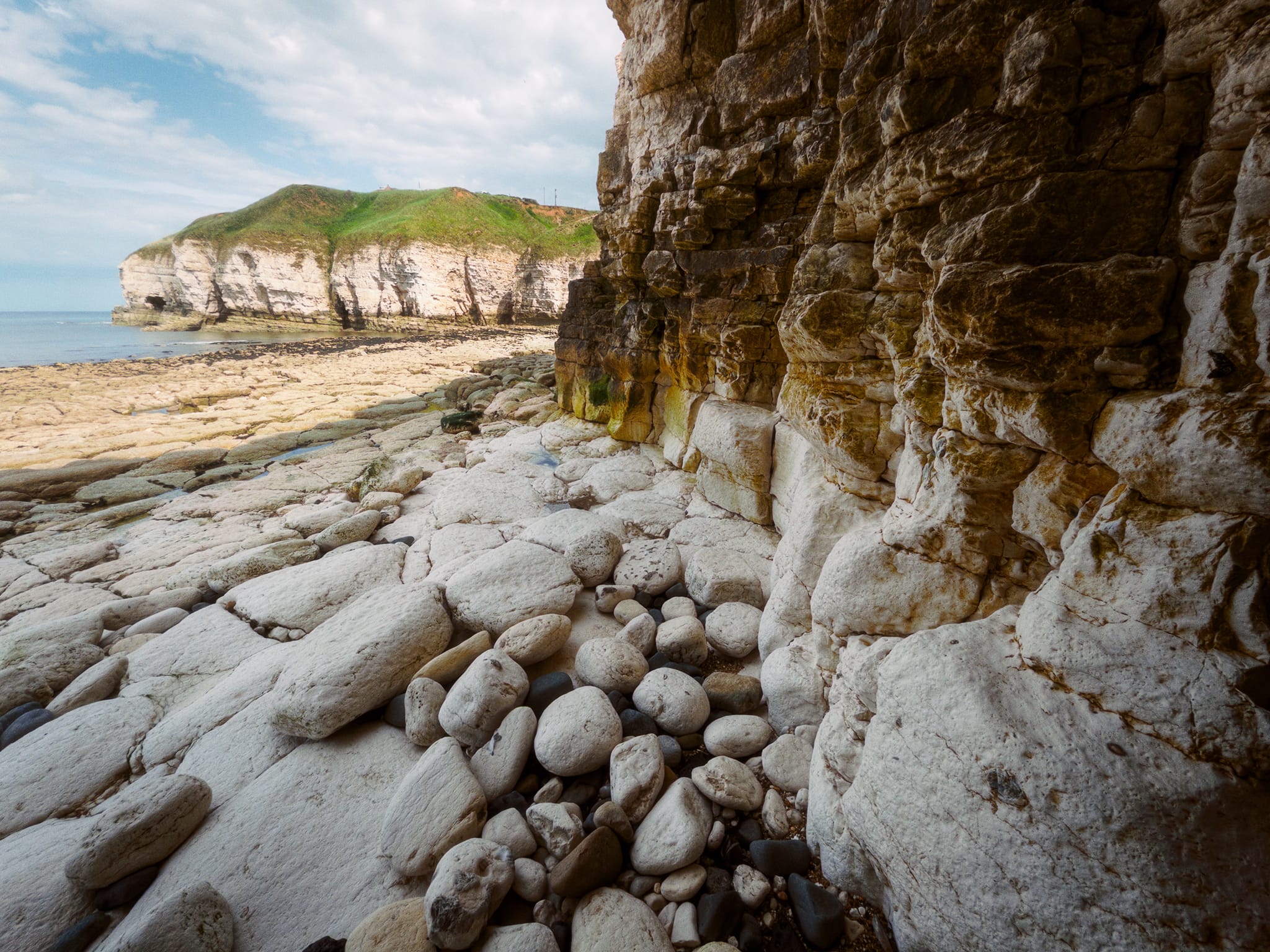 I tucked myself deep under the cliffs to get the contrast between shade and the light striking Thornwick Bay’s eastern cliffs. A nice contrast of dark and light, smooth and blocky, boulders and pavement.