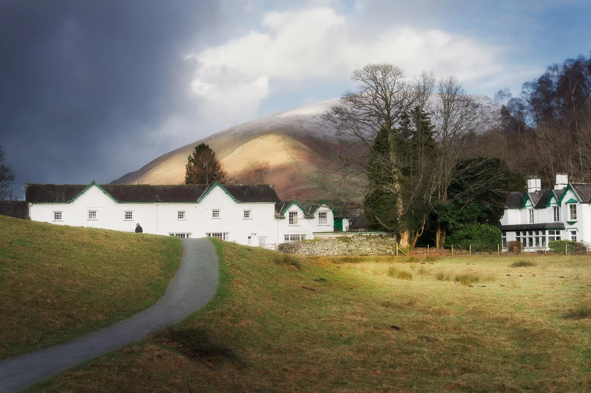  The trail in the direction of Allan Bank enjoys wonderful views towards Helm Crag and Seat Sandal. Here, the latter of the two fells is stroked by golden afternoon light across its flanks. 