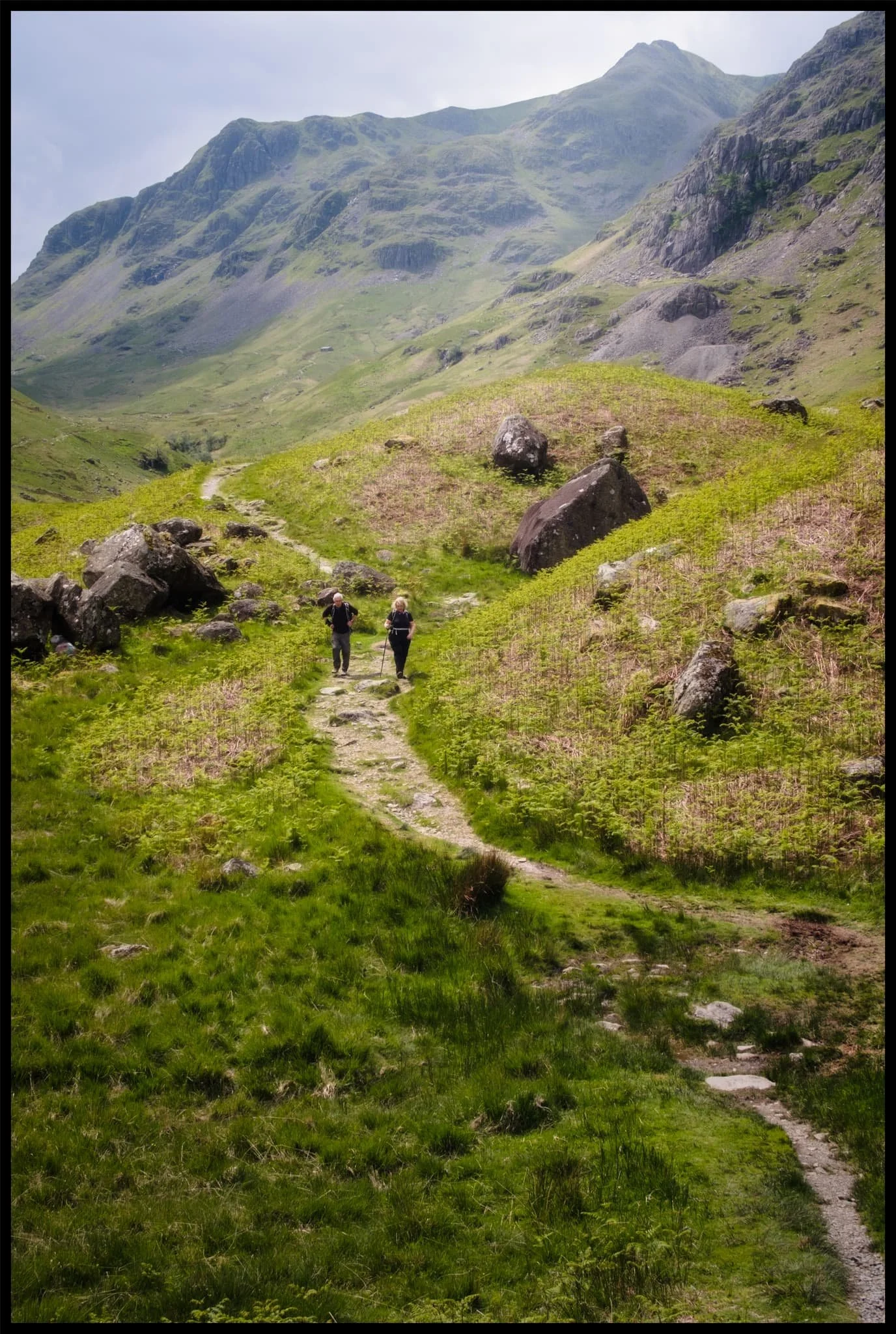  Another look back at Grisedale&rsquo;s magnificent backdrop, with fellow hikers not far behind us. 