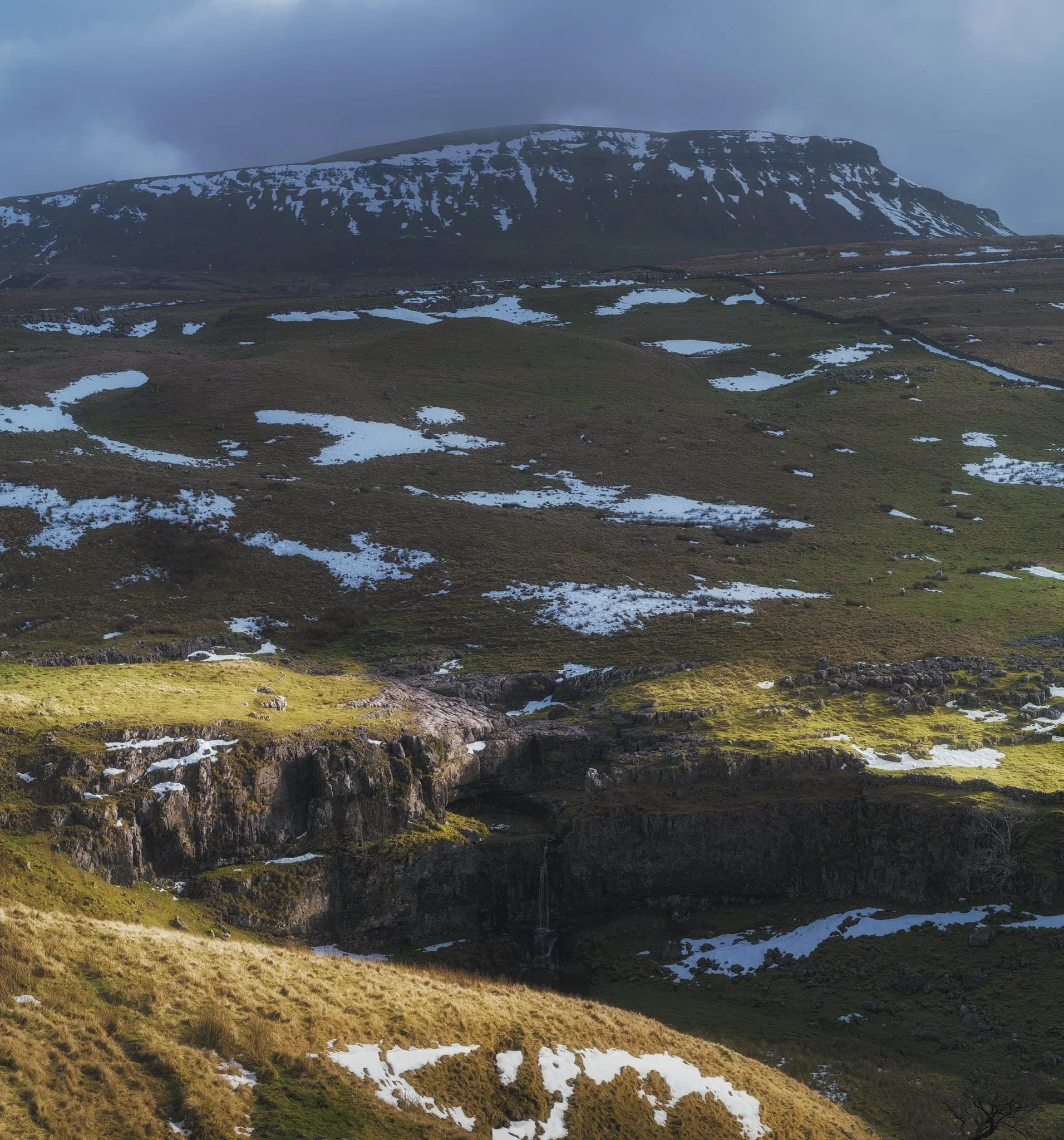 A good sign: A small waterfall where there usually isn’t at Horton Scar. Above, Pen-y-Ghent fights with the dark and stormy clouds.