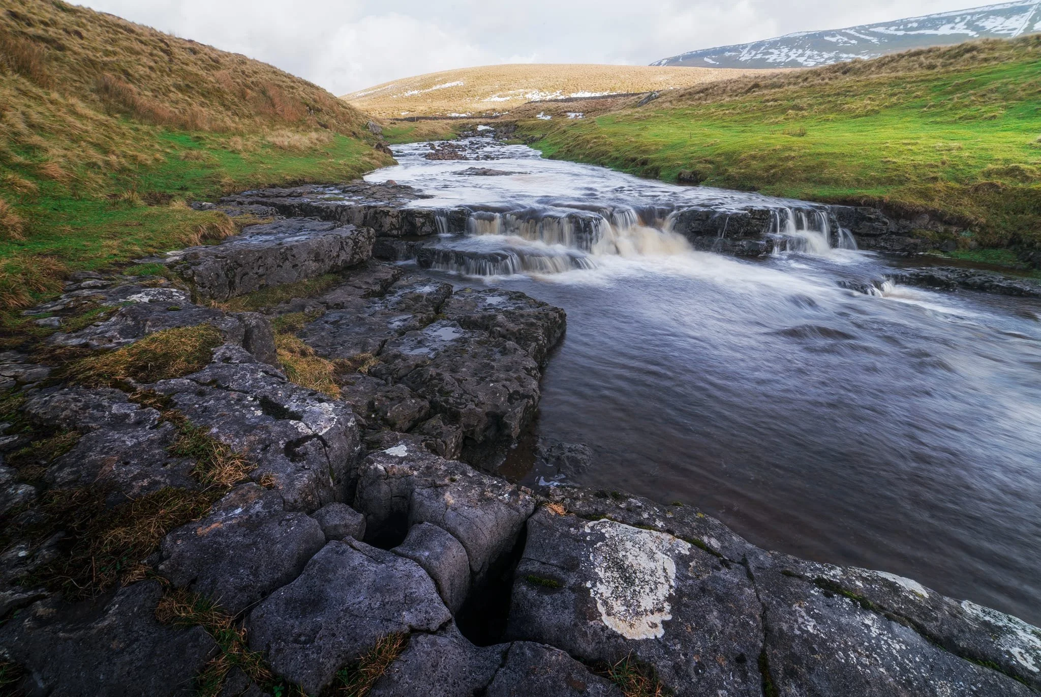 Looking up Hull Pot Beck and its many cascades. By the normal way of things, this beck is dry as it usually disappears into the maze of caves beneath Pen-y-Ghent before it reaches Hull Pot. With all the rain and snow we’ve had, the beck was able to complete its route, crashing 60ft down into Hull Pot and re-emerging at the surface nearer Horton-in-Ribblesdale.
