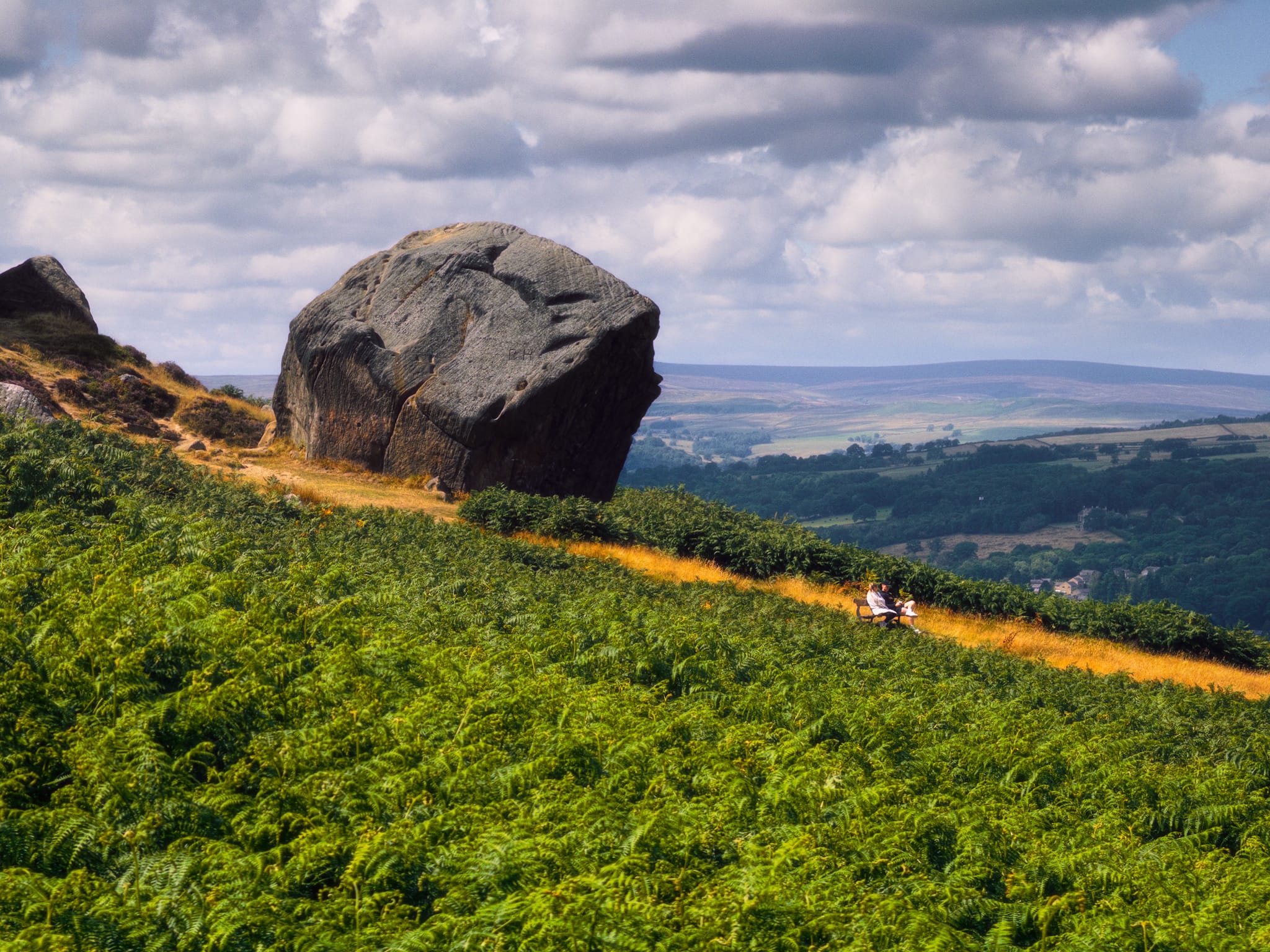 This frankly massive boulder, seemingly invading the privacy of the couple lower down the slope, is the &ldquo;Calf&rdquo; of the Cow and Calf. The Calf is said to weigh about 1,000 tonnes, separated from the Cow within the last 10,000 years.