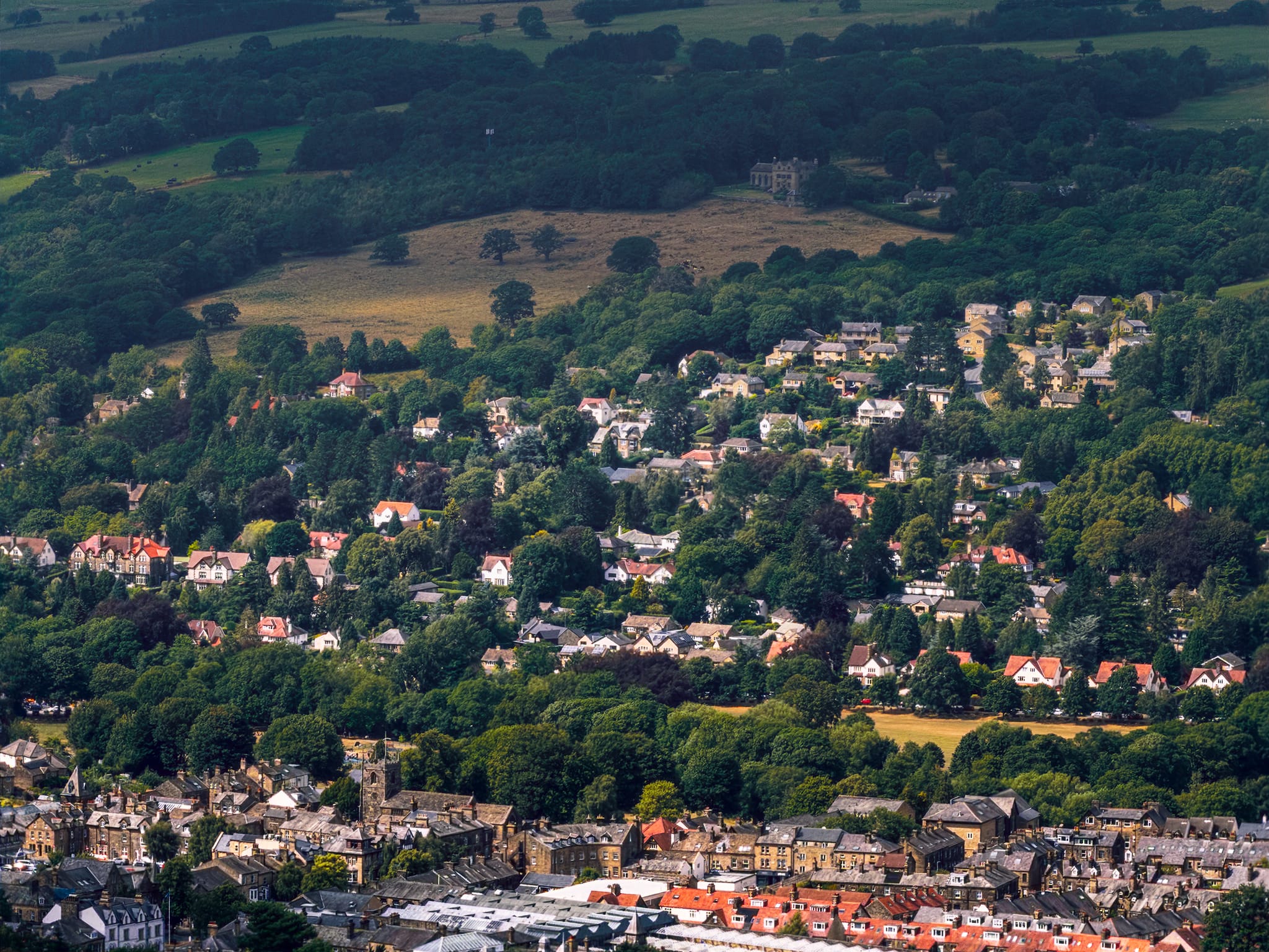 The panoramic views from Ilkley Moor are immense. Zooming in tight, I pick out the valley side above Ilkley, light scanning across the fell side, with an isolated manor higher above in the shadow of a cloud.