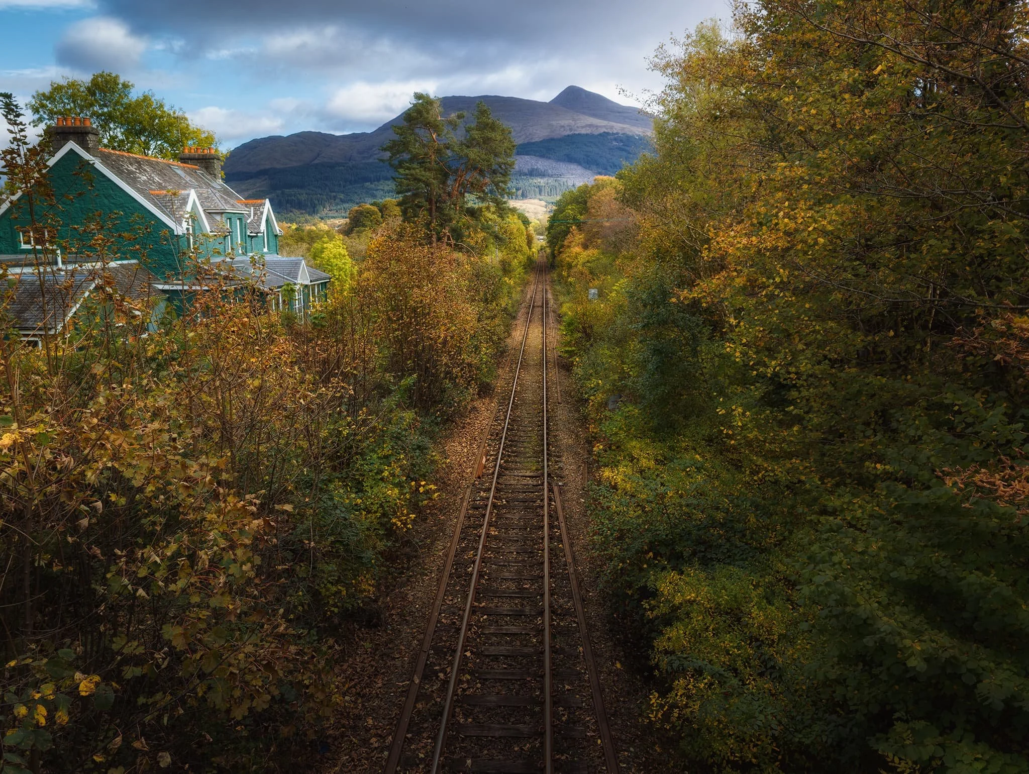  Heading back into the village a bridge crosses over the West Highland Railway line, offering a perfect leading line all the way towards the unmistakable shape of  Ben Cruachan . 