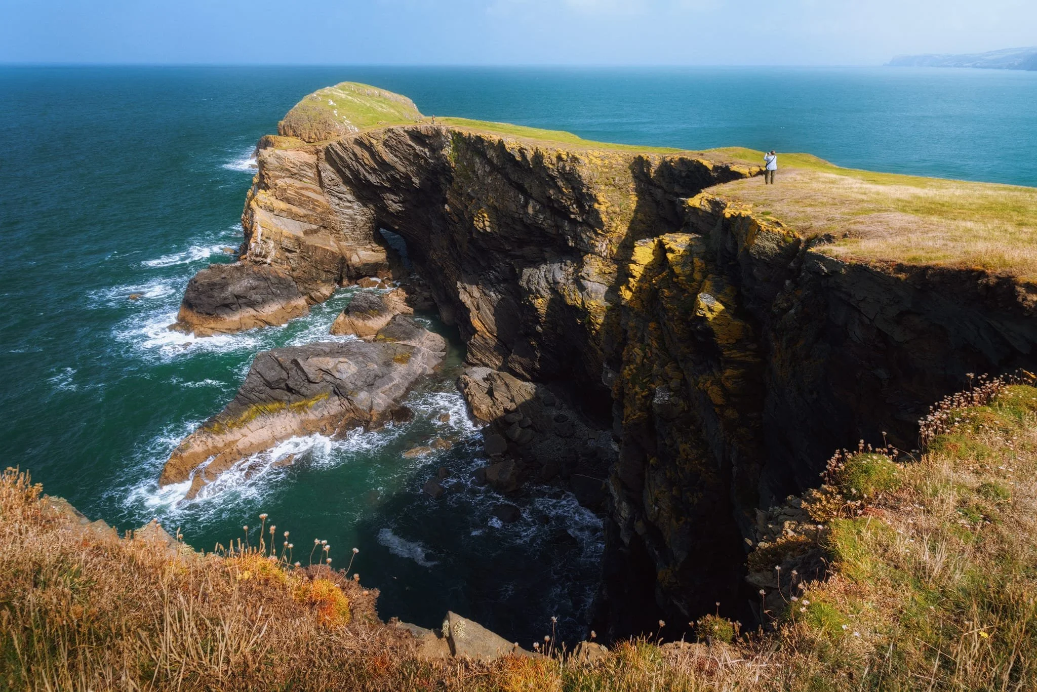  The peninsula was full of otherworldly and unusual geology. Sea caves, folds, synclines and anticlines, sea stacks, the works. My lovely Lisabet in the distance provides scale for the sheer drop of these cliffs into the Irish Sea. 
