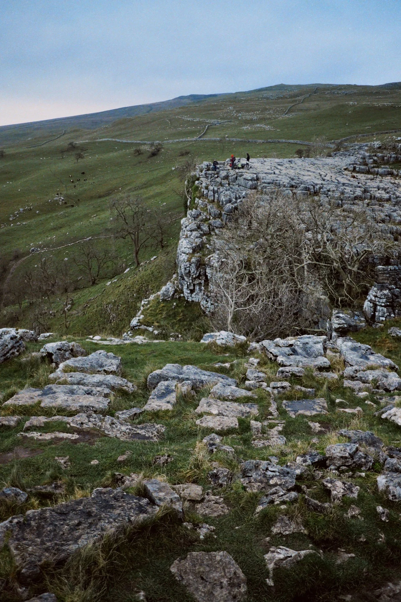  At the eastern shoulder of Malham Cove&rsquo;s curve we could look all the way back to the main cliff face, and see the tiny little people near its edge. 