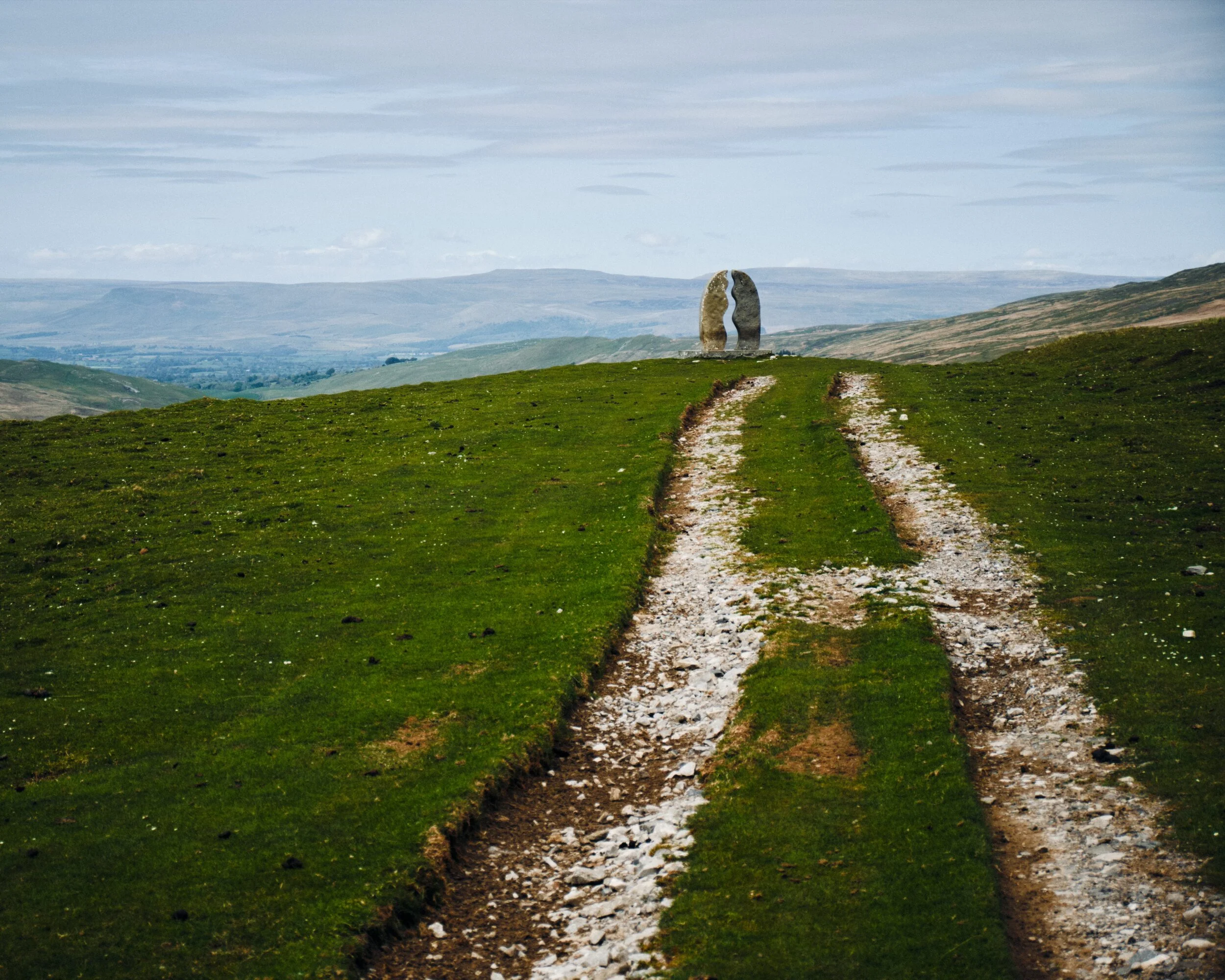  Up on Pennine Bridleway, our goal is in sight. Overhead the clouds dissipate and we clearly make out the escarpment of the Northern Pennines. 