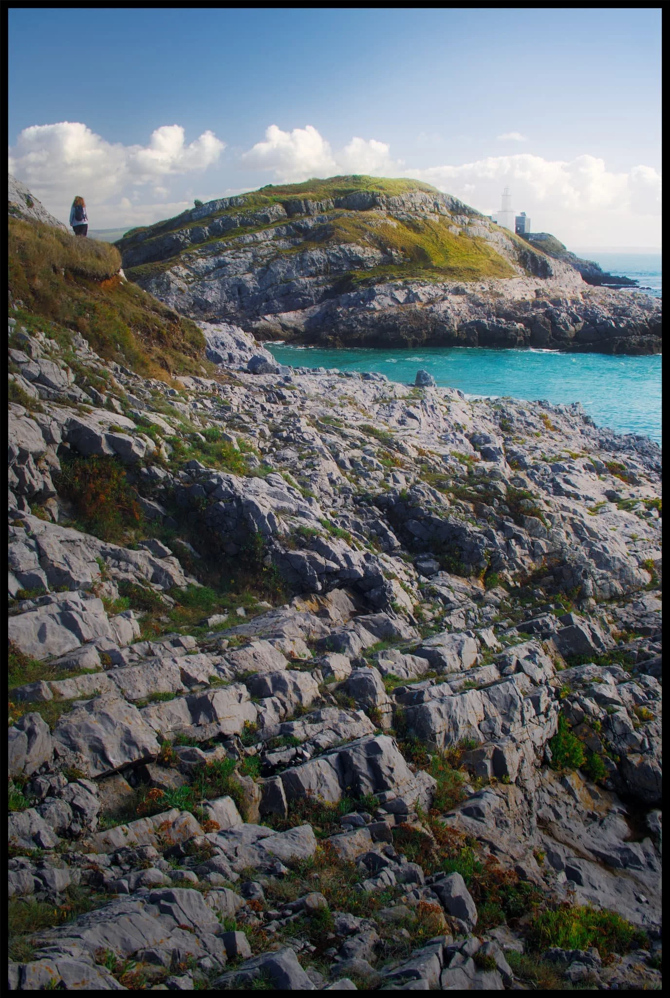  My lovely Lisabet high above the crags of Mumbles Head. Middle Head and Mumbles Lighthouse were starting to catch the sun as it appeared behind the clouds. 