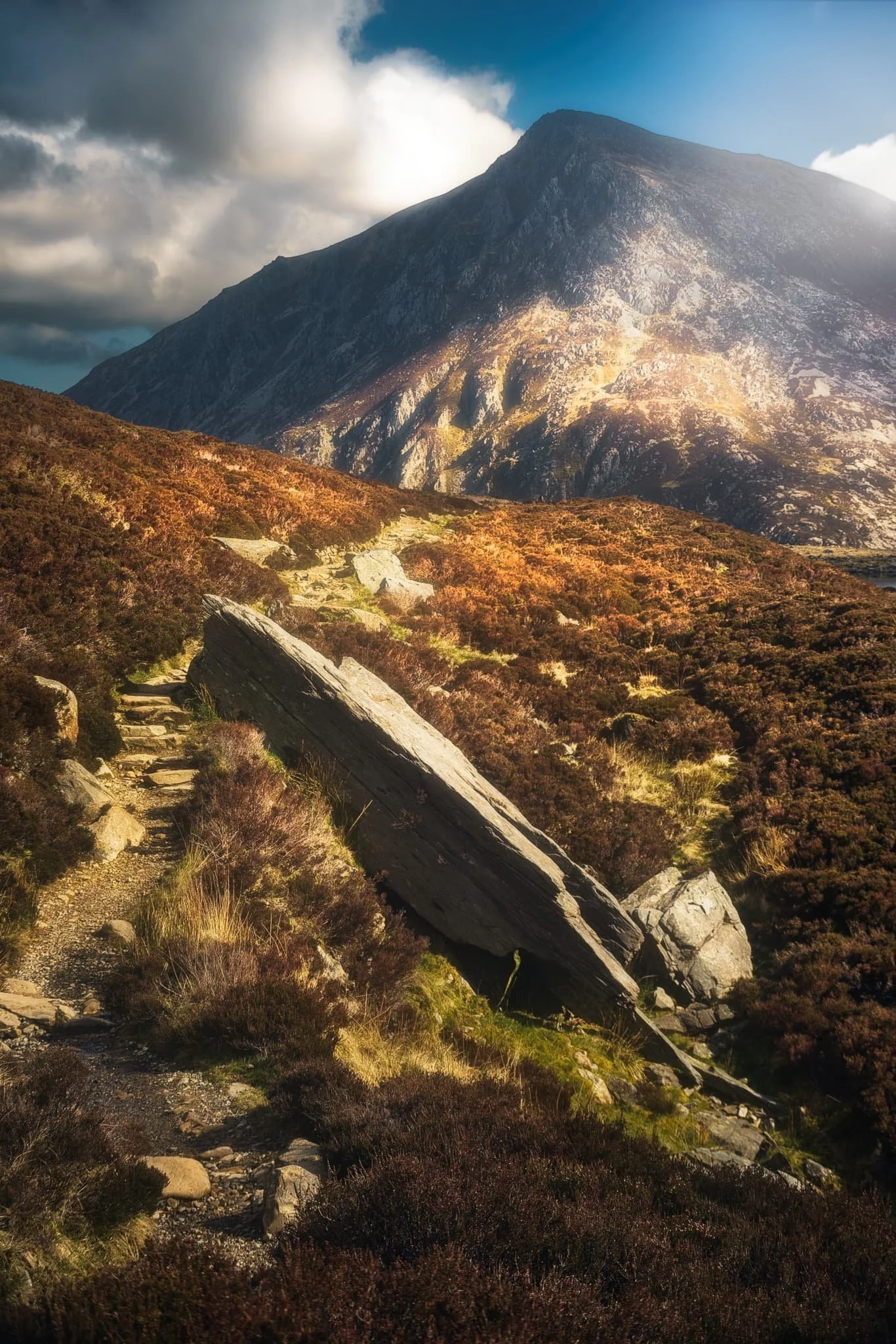  A glacial erratic nearly blocks the trail. It also gives a lovely foreground interest against the emerging morning light drenching Pen yr Ole Wen. 