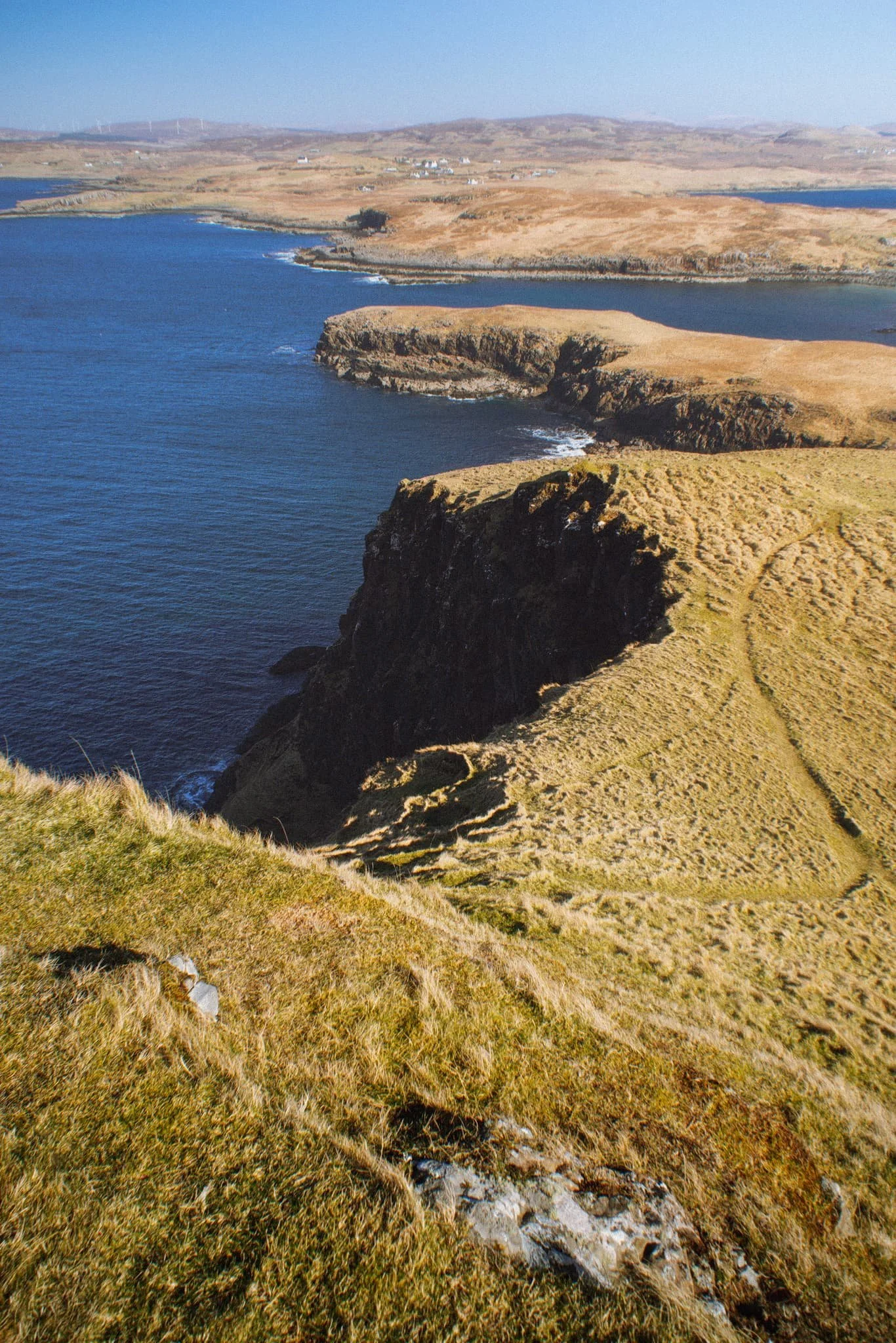 A simple leading line of Oronsay’s cliff edges, all the way back to Ullinish and the moorlands of Skye.
