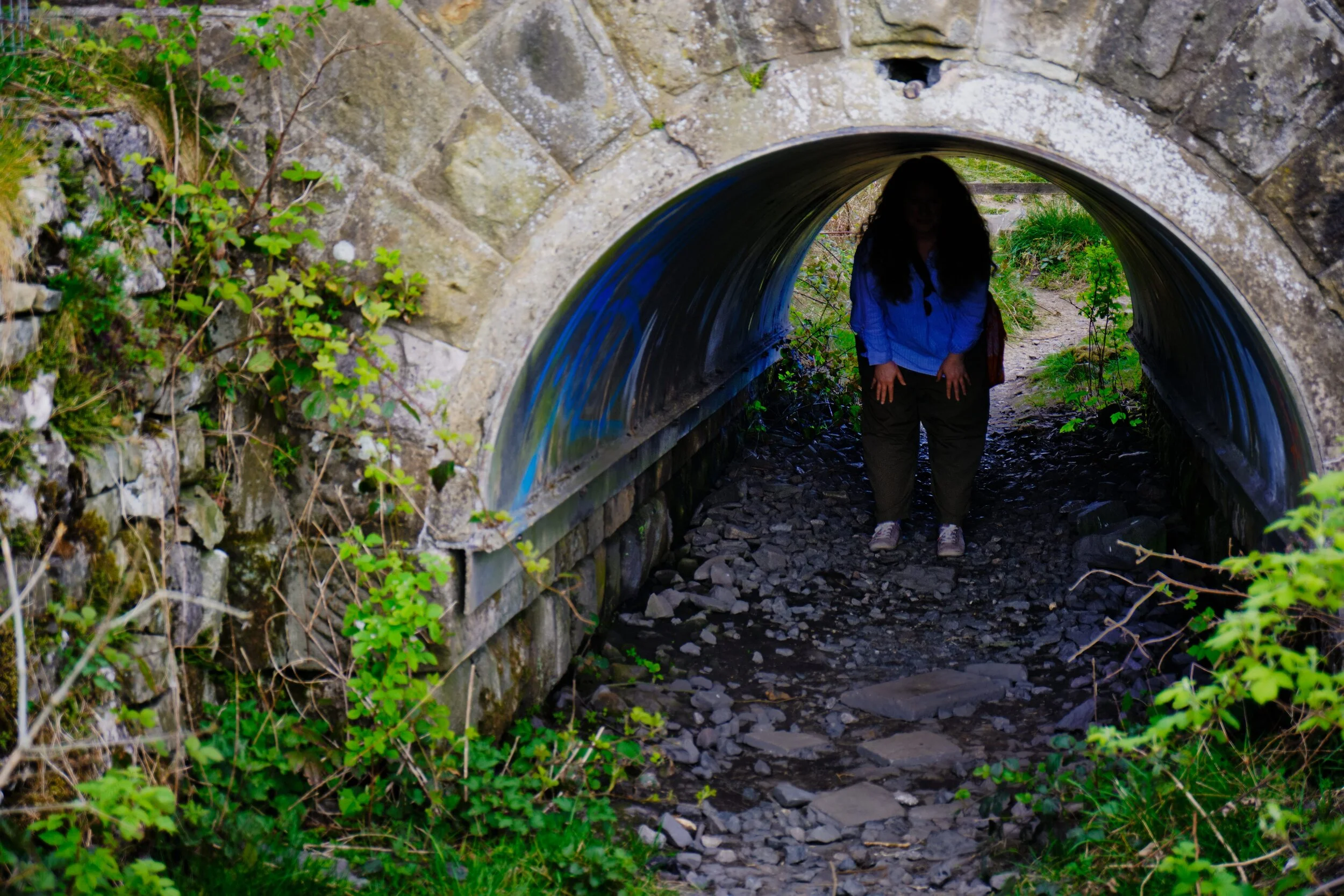 This is the pedestrian tunnel that crosses underneath the railway line. My lovely Lisabet here, demonstrating how low it is (she&rsquo;s around 5ft 3in and had to hunch over). 