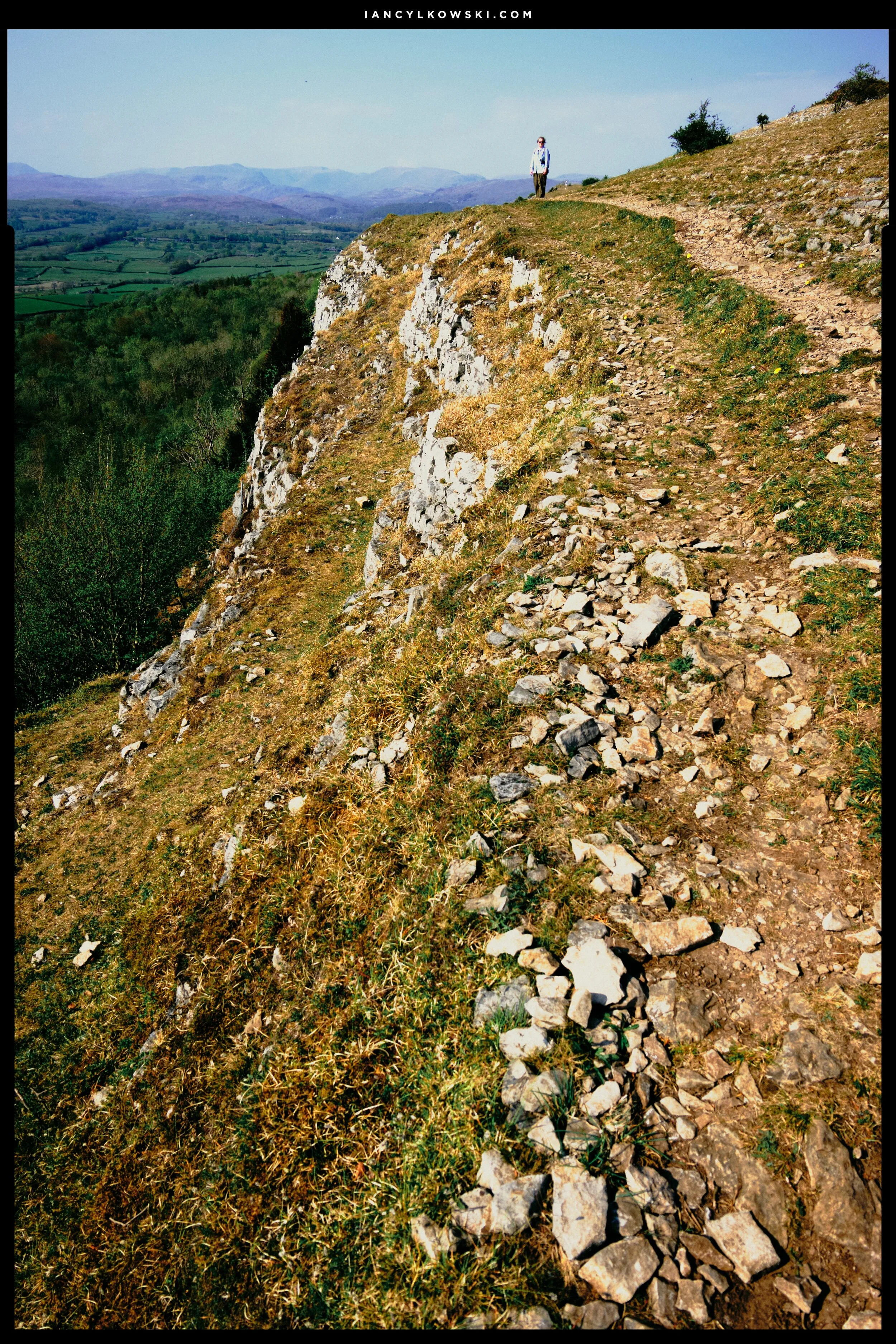 My lovely Lisabet, no doubt nervously watching me as I frame this composition along the edge of Scout Scar.