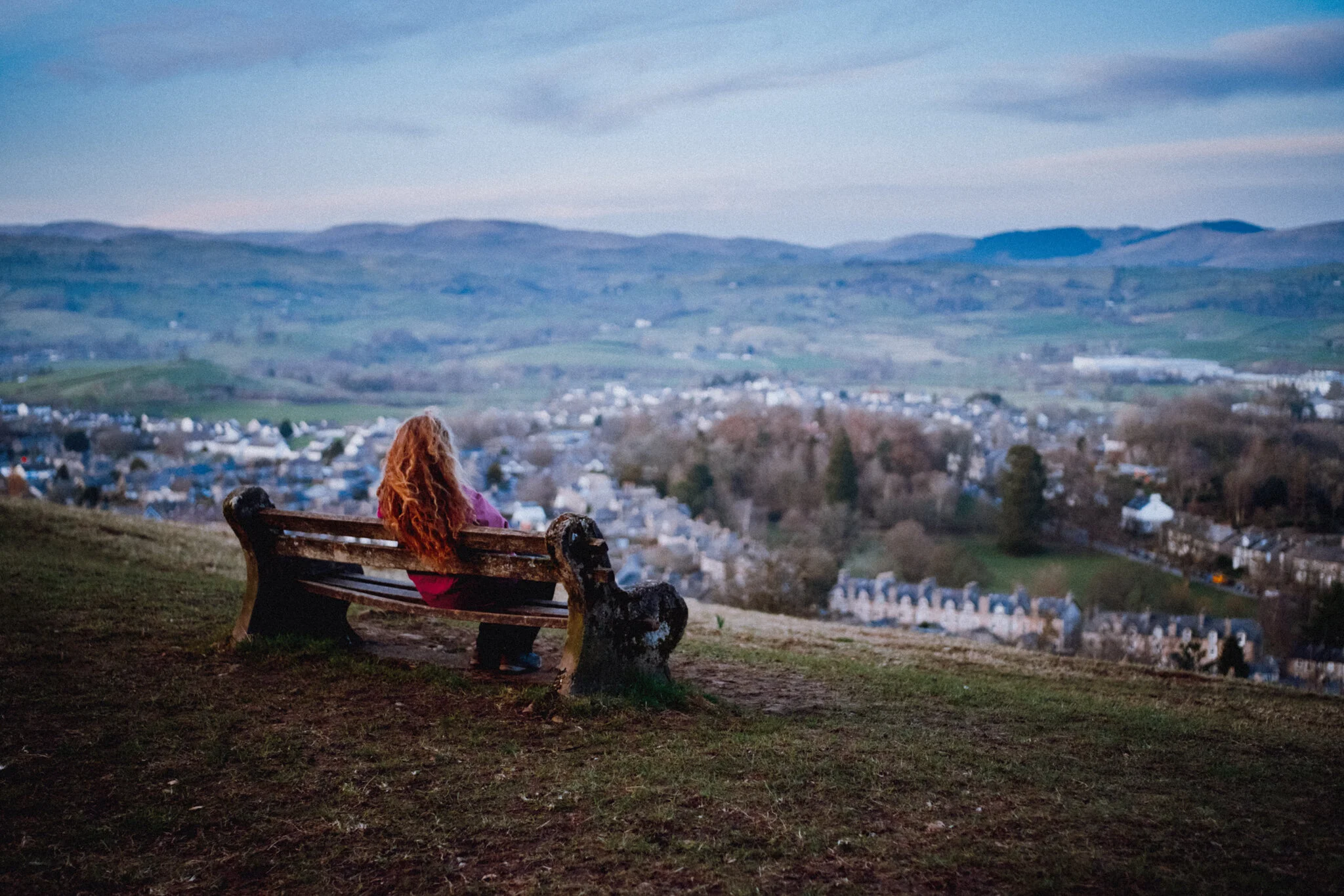  Once you pop out of the top of Serpentine Woods, an old bench invites you to rest and take in the view across Kendal towards the Eastern Lake District fells. Lisabet happily did so. 