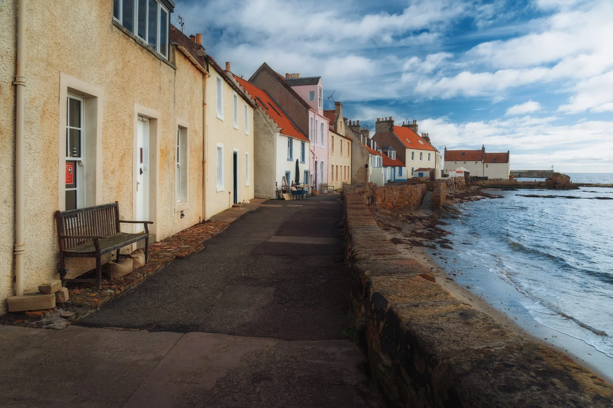  Pittenweem developed as a fishing village probably centred around an early Christian religious settlement. It likely started from the western shoreline, where these cottages are; here, the sheltered beaches were safe places for fishermen to draw their boats up out of the water. 