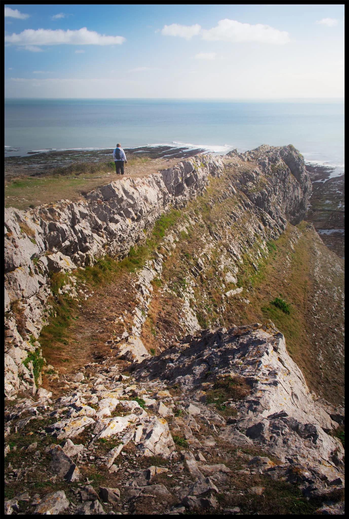  West of the beach one can hike up the cliffs to summit Port Eynon Point. My lovely Lisabet pictured here heading straight for the knife-edge tip of Port Eynon Point. 