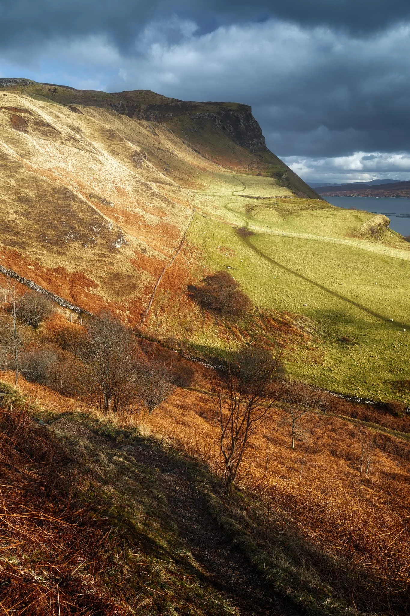 We followed the trail further down the coastline until it abruptly turns inland near this area of flat land. The path then zigzags up the steep hillside of Ben Chracaig. Halfway up, lighting conditions changed and I quickly nabbed this dramatic shot.