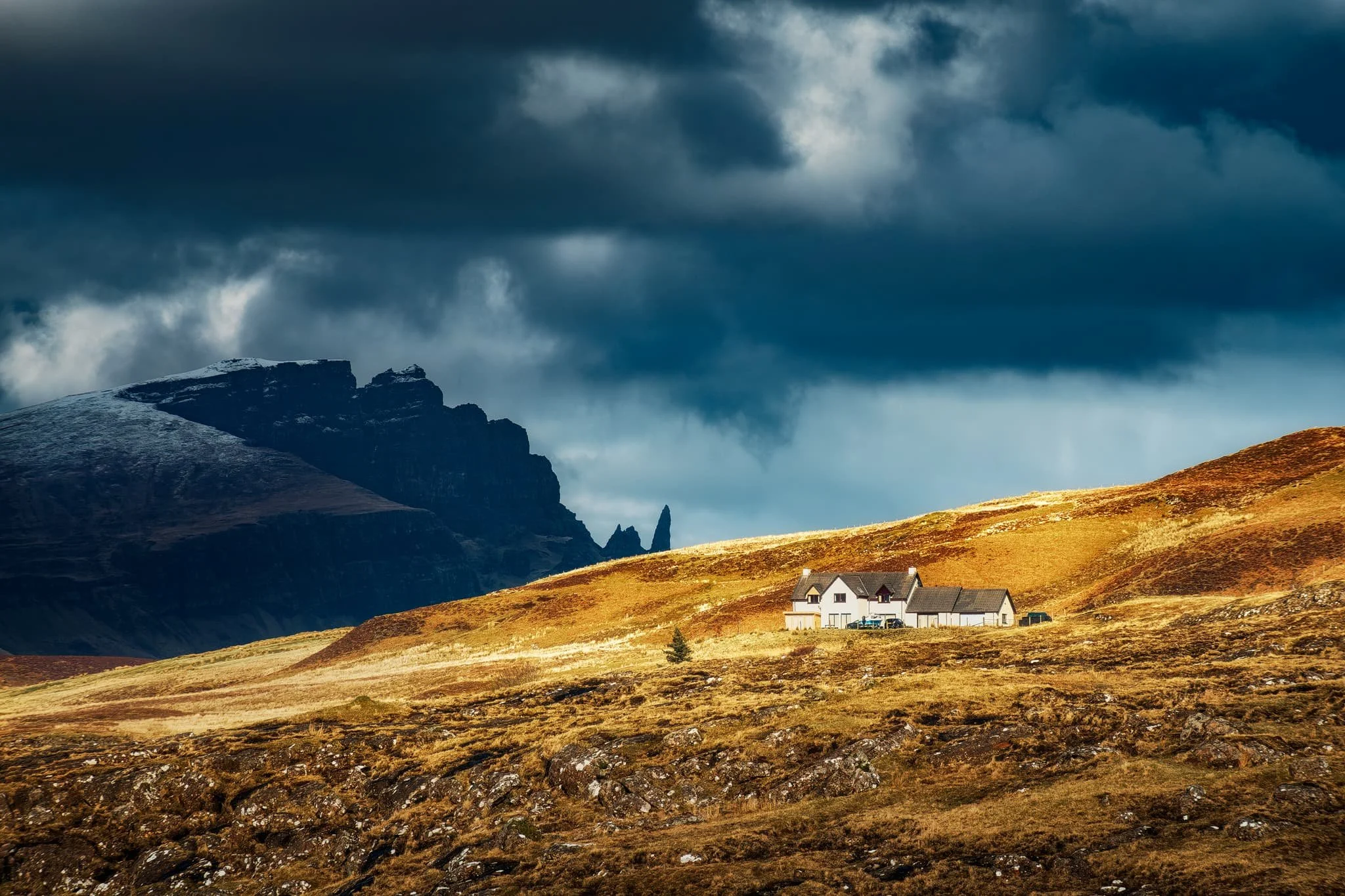 Away from the cliffs and onto the moorland above Portree, this frankly ridiculous scene revealed itself to us. The Storr, lightly dusted in snow, with a thick and dramatic storm above, whilst the Portree moorlands and this house receive a strong burst of sunlight from behind us.