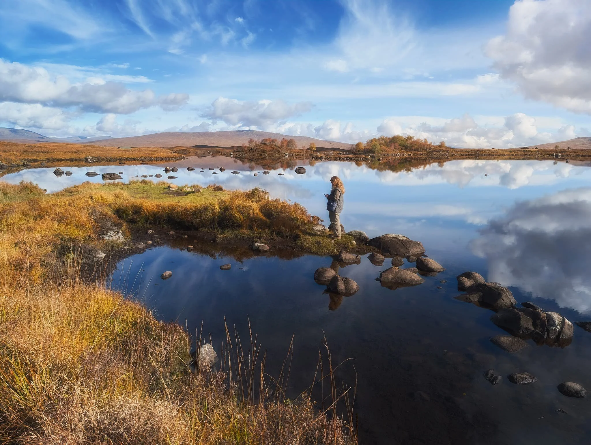 Looking northeast across the loch, I line up this composition with the loch’s glassy reflections, the distant hills, and my Lisabet ensuring she’s captured what she wanted.