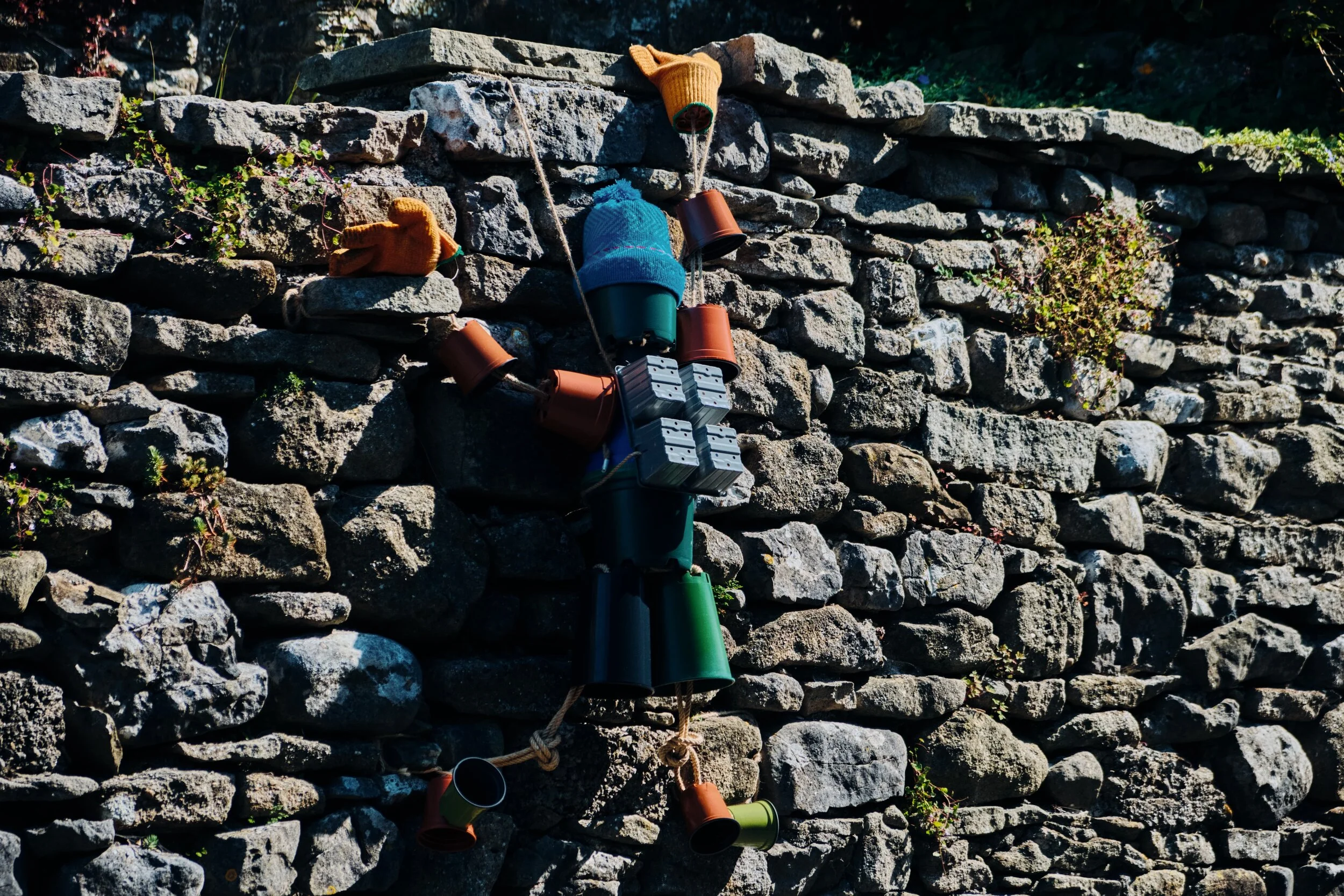  In August and September Settle is home to the  Settle Flowerpot Festival  (seriously), where local residents create all kinds of monuments, statues, and amusing scenarios using flowerpots. Here, a mountain climber scales the wall. 