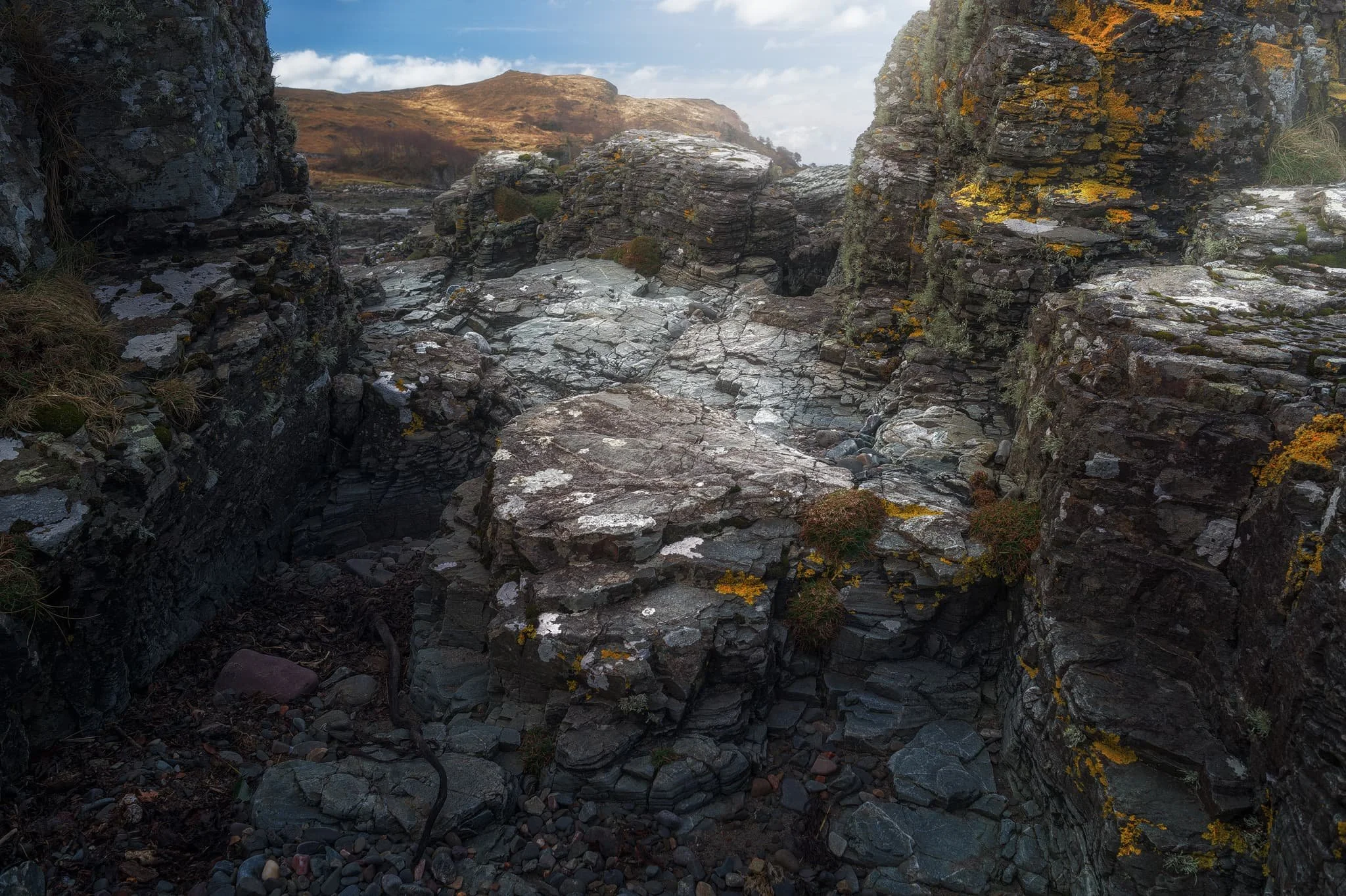  Arriving at Tarskavaig Bay, Lisabet and I quickly wandered off to explore and photography. I found this fascinating person-high crag on the beach, and clambered within its nooks and crannies looking for compositions. These are Lewisian Gneiss again, but have been squashed and stretched so much that they&rsquo;ve become very fine-grained and have lots of cracks. They also have minerals like chlorite and epidote in them. 