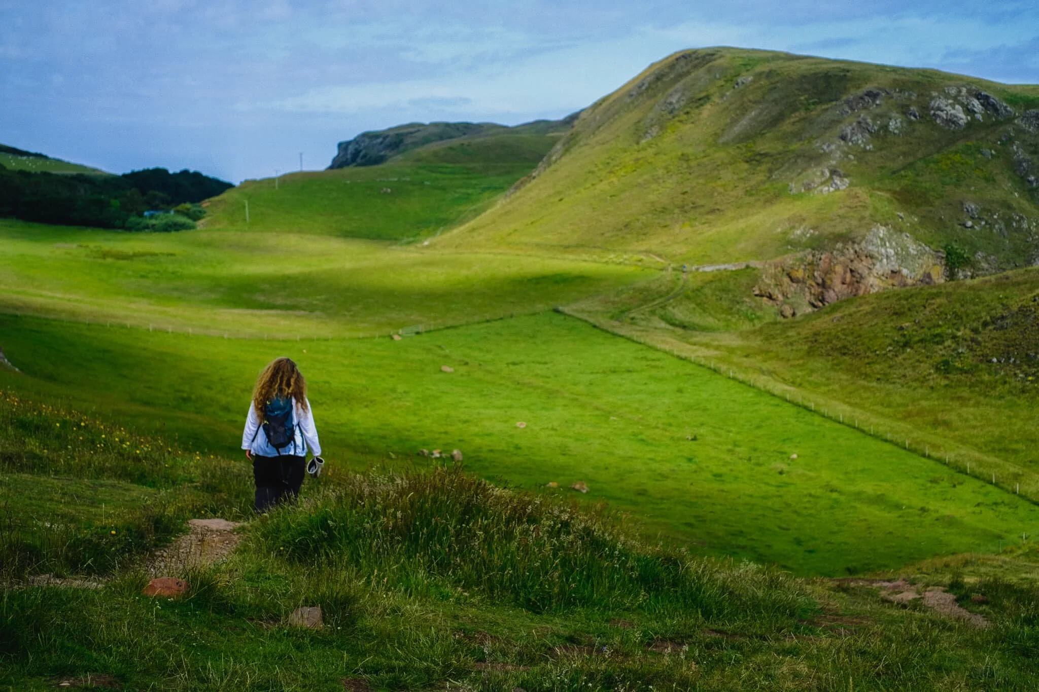  Onward from Wuddy Rocks, we aim towards the main headland of St. Abb&rsquo;s Head itself. The shadows of clouds glide across the golden farmland below. 