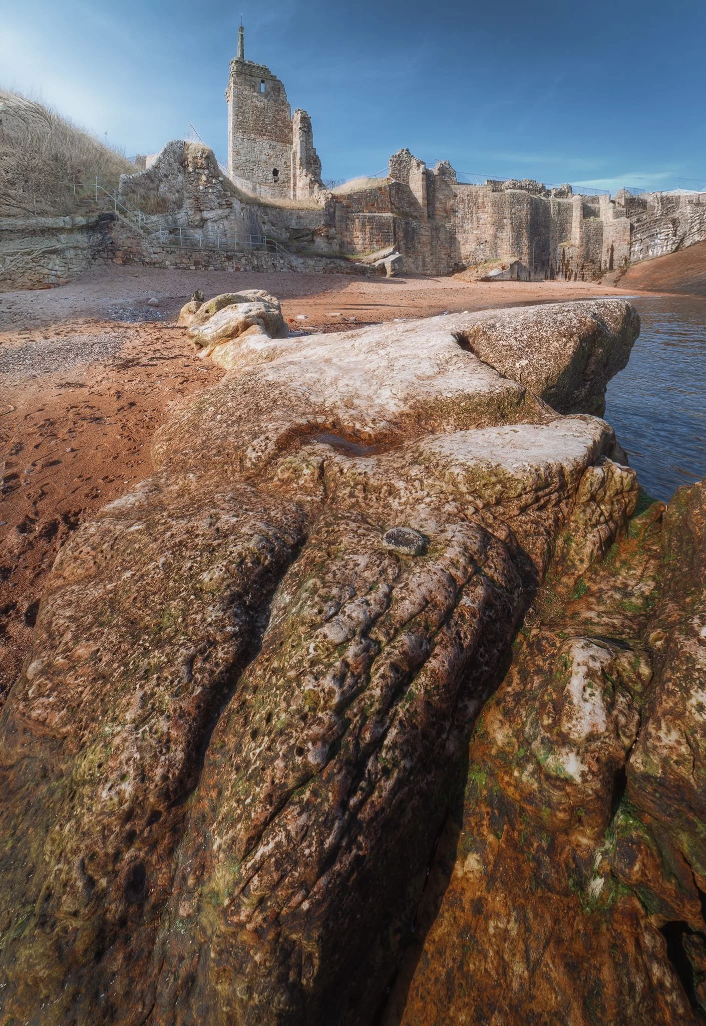  Now, it was time to have a look at the ruins of St Andrews castle. As it sits on a rocky promontory overlooking the sea, we wanted to check it out first from below. This beautiful long rock formation served as the perfect leading line. 
