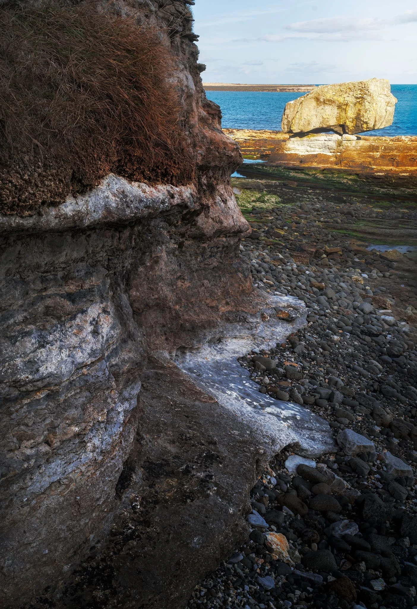 Below the cliffs at An Corran, the rocky coastline is dotted with giant boulders, often situated on top of raised platforms. Millennia of coastal and wind erosion have carved them into fantastic shapes. 