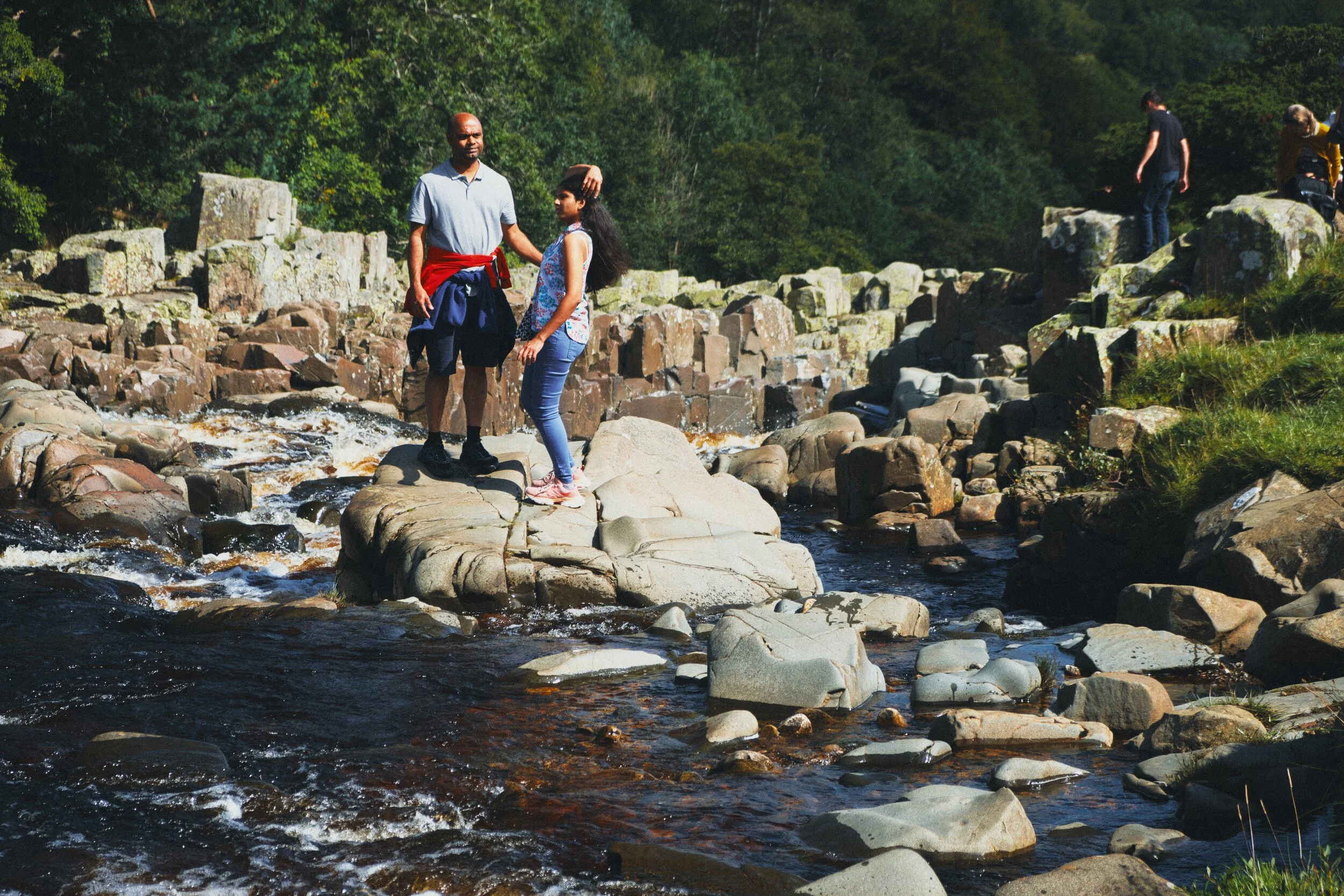 Families enjoy the sites and sounds of the Tees, hopping between boulders or pausing for food and drink.