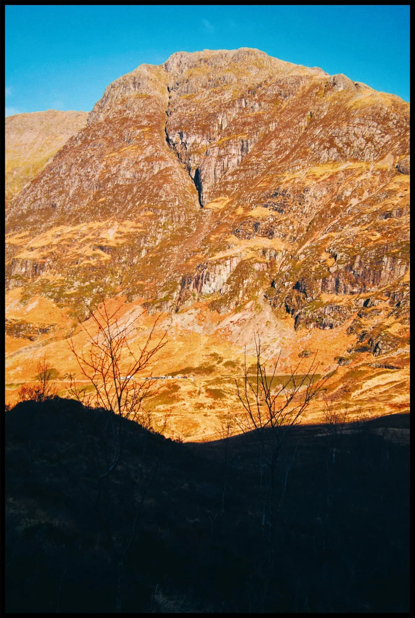  As we began hiking up the trail in between Beinn Fhada and Geàrr Aonach, the sheer ridge face of Aonach Eagach was being drenched in morning wintersun. 