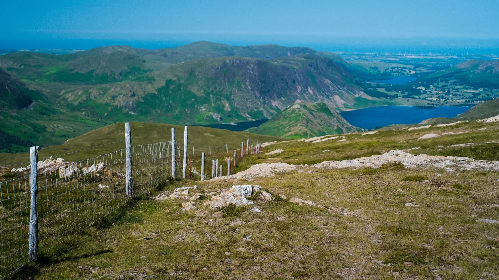 Nearing the top of Robinson. The small isolated fell of Rannerdale Knotts comes into view, followed by Crummock Water and Mellbreak above it. We can now see beyond the Lake District out to the Irish Sea.