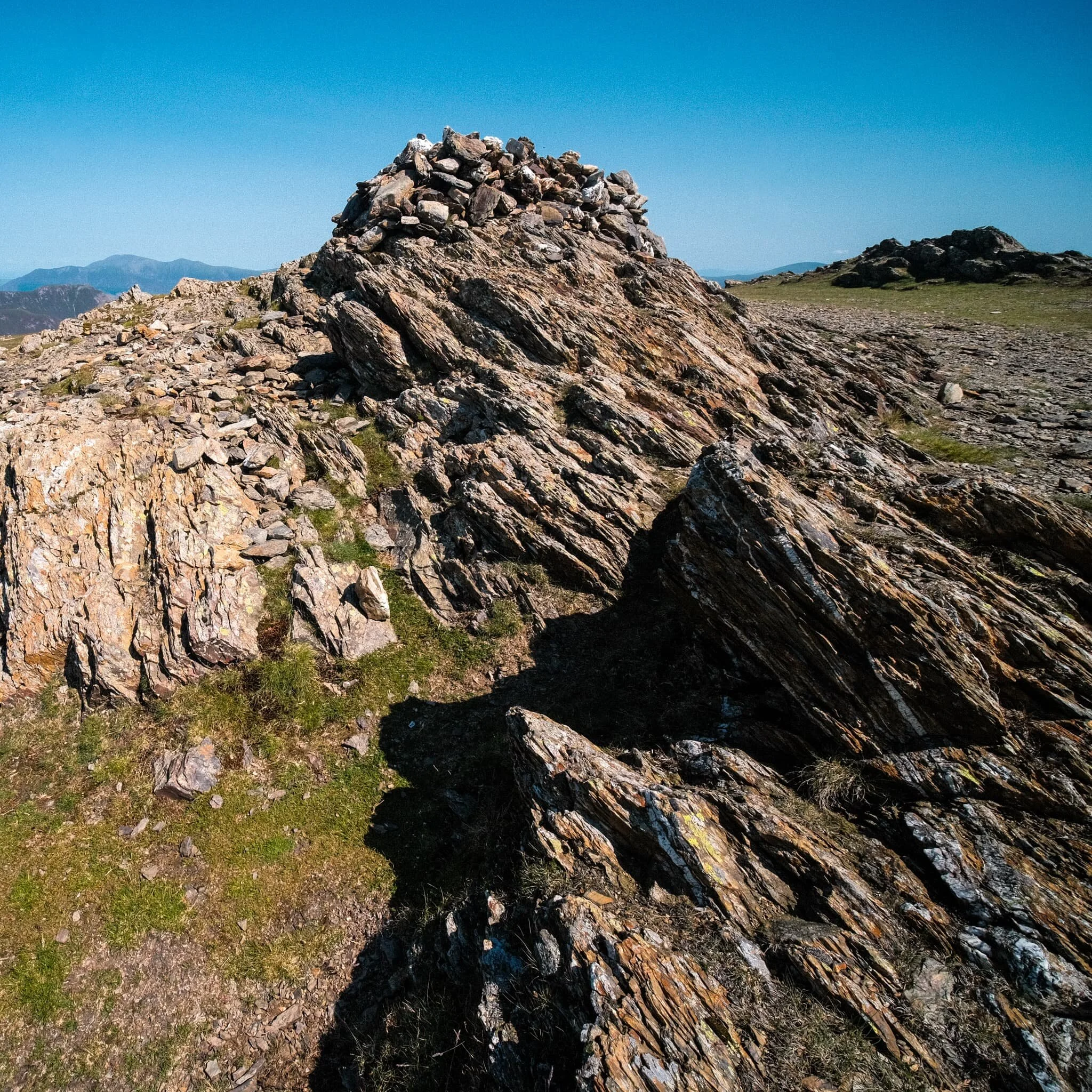 Fascinating geology. This is apparently an “olistostrome of disrupted, sheared and folded mudstone, siltstone and sandstone”. I also liked in this composition our the pile of rocks on the right mirrored the shape of the Skiddaw range to the left.