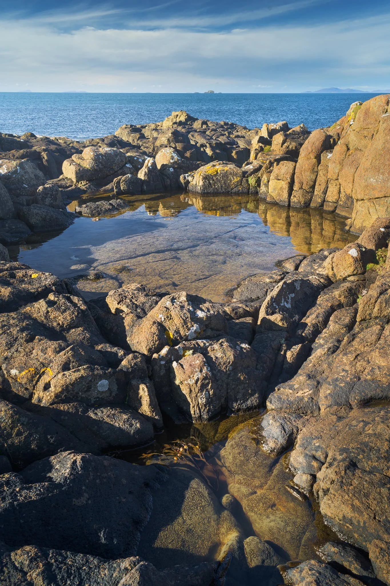 Further west away from the castle ruins we could even spot across the sea here, known as the Little Minch, the islands of Lewis and Harris. I couple of crystal clear rock pools helped me create some sort of coherent composition from the chaos of rock joints.