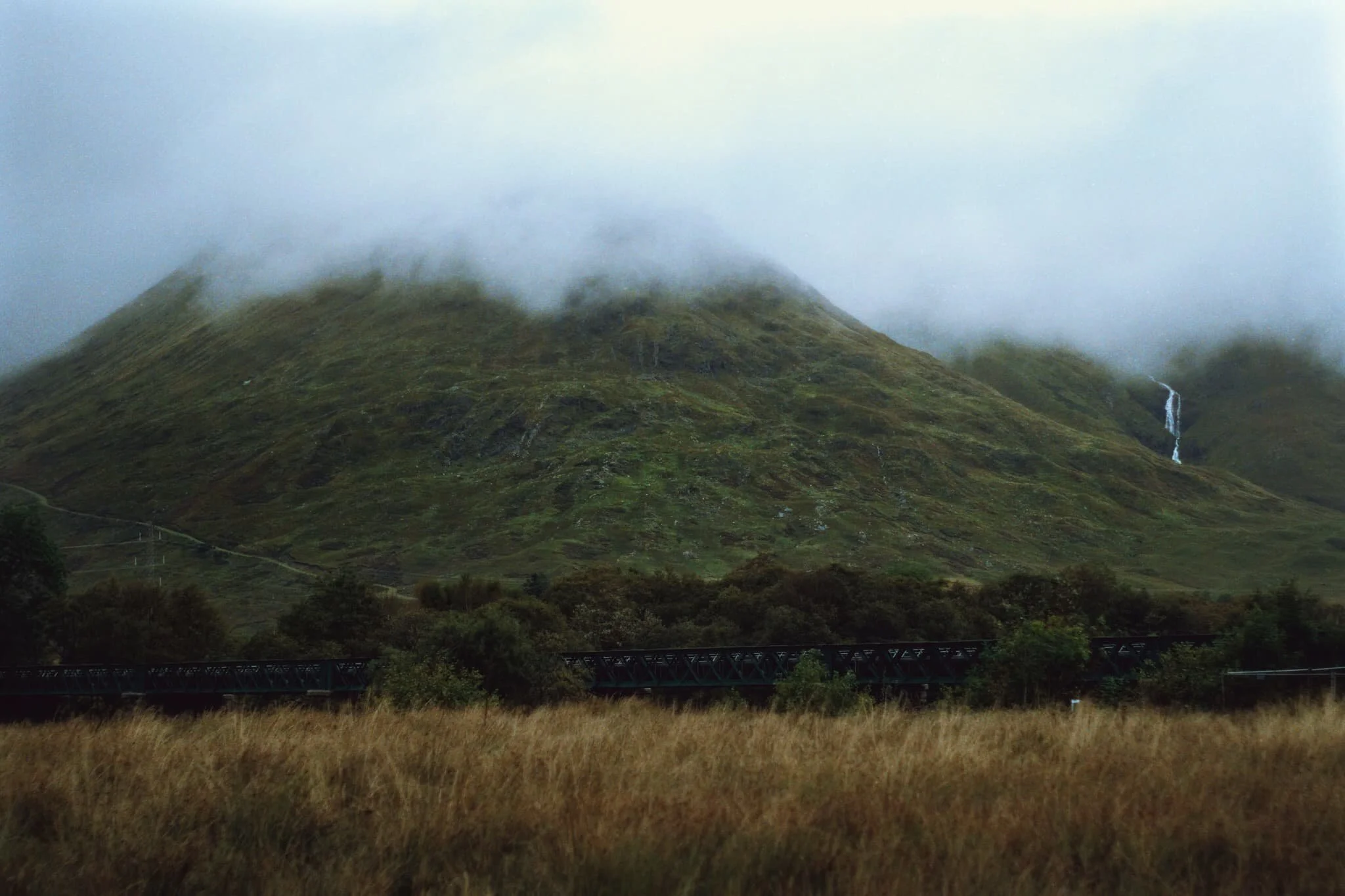  Across the valley from Ben Cruachan is Beinn Eunaich (989 m/3,245 ft) with the waterfall  Steallair Eùnaich  rushing down its flanks. On this day, the clouds did not leave the mountain tops. 